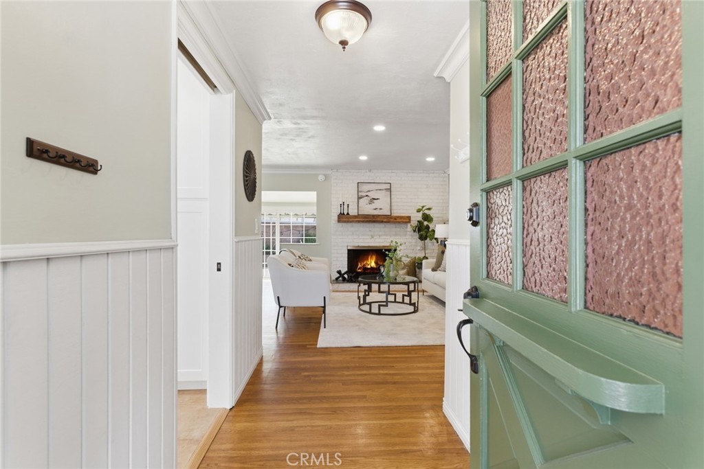 Welcome to 9309 Swinton Avenue, a beautiful single-story home in the heart of North Hills West that perfectly blends mid-century charm with thoughtful modern updates. The expansive front yard, ample driveway, and charming front porch set the stage for curb appeal and effortless everyday living. This spacious 4-bedroom, 2-bath residence spans nearly 1,900 square feet on a generous 7,500-square-foot lot, offering warmth, comfort, and functionality throughout. The inviting living room features gleaming hardwood floors and abundant natural light, seamlessly connecting to the formal dining area. The upgraded kitchen is a cook’s delight with quartz countertops, a gas range, custom cabinetry, and a cozy breakfast nook. A step-down family room provides the ideal gathering space with a sliding door leading to the private backyard. The primary suite includes a charming window seat, ample closet space, and a beautifully tiled ensuite bathroom, while the additional bedrooms offer hardwood floors, generous closets, and versatility for guests or office use. A full hall bathroom features dual sinks and a shower-tub combination. Additional highlights include copper plumbing, double-pane windows, central HVAC, retrofitted foundation and a composition roof for peace of mind. The attached two-car garage provides extra storage and convenience, while the fully fenced generously-sized backyard is perfect for entertaining with a covered patio and room for gardening or play. Situated on a quiet residential street near shopping, schools including Heritage High School, a 9-hole golf course, and easy freeway access, offers the perfect balance of classic style, modern comfort, and a prime San Fernando Valley location.