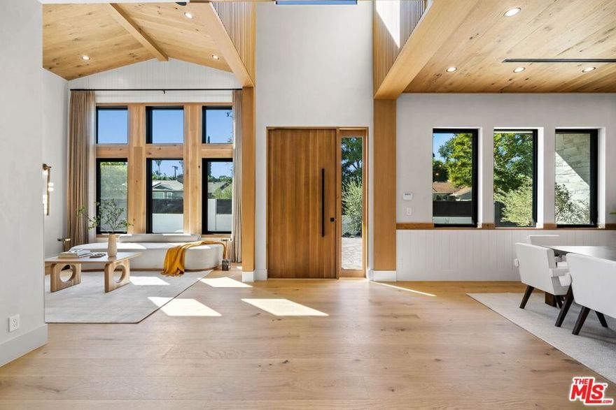 Welcome to the epitome of modern luxury nestled in the exclusive Amestoy Estates! Every inch of this breathtaking residence, thoughtfully crafted by Ossi Designs, speaks to sophistication and artistry. Enter and be captivated by this brand-new Traditional masterpiece, where precision craftsmanship meets visionary aesthetics. Step onto the European oak floors, which guide you through an open layout flawlessly integrating spacious living and dining areas with seamless indoor outdoor experience.At the heart of this home lies a bespoke chef's kitchen, an absolute showpiece featuring custom solid oak cabinetry, exquisite Taj Mahal quartzite leather-finish countertops, and elite Thermador appliances. Ascend to the upper level to find a serene primary suite with a private balcony, rustic oak ceilings, and a luxurious ensuite bathroom, offering a peaceful retreat. Each upstairs bedroom is a showcase of elegance, embodying meticulous attention to detail.Outside, an expansive backyard paradise awaits, inviting you to unwind by the sparkling pool, relax under the covered cabana beside a cozy fireplace, or savor culinary creations at the fully-equipped BBQ area. For recreation, a private sports court adds a spirited touch, perfect for games and entertainment. The detached ADU, filled with natural light from grand glass doors, offers a charming separate living space with its own bedroom, bathroom, and full kitchen, perfect for guests or rental potential.Indulge in cinematic experiences in the dedicated home theater, adding a layer of entertainment within your own residence. Further elevating the lifestyle is the advanced Control4 smart home system, ensuring integration of lighting, climate, security, and entertainmentall at your fingertips. This Encino estate redefines upscale living, blending timeless elegance with cutting-edge technology and offering a lifestyle of luxury beyond compare.