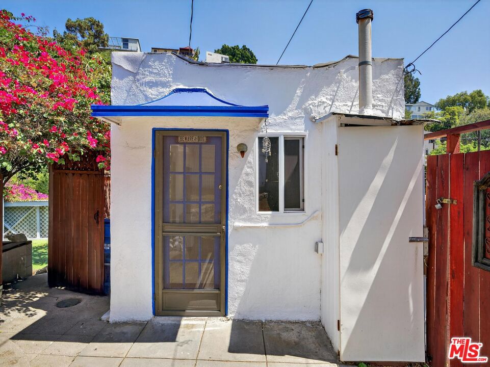2565 1/2 Glen Green is a charming studio, complete with full bath, kitchenette, and its own patio space, set behind a hedge of bougainvillea on a terraced 2-unit property along one of the best side streets in all of the Canyon. The lease also comes with an additional converted garage flex/space that has been used previously as a film editing office and could be utilized as a gym, music studio, or otherwise. The studio and main cottage have been rented separately to long for years. While they share the a main gated entrance, each unit features it's own private entrance. Owner pays pest, gardener and water.