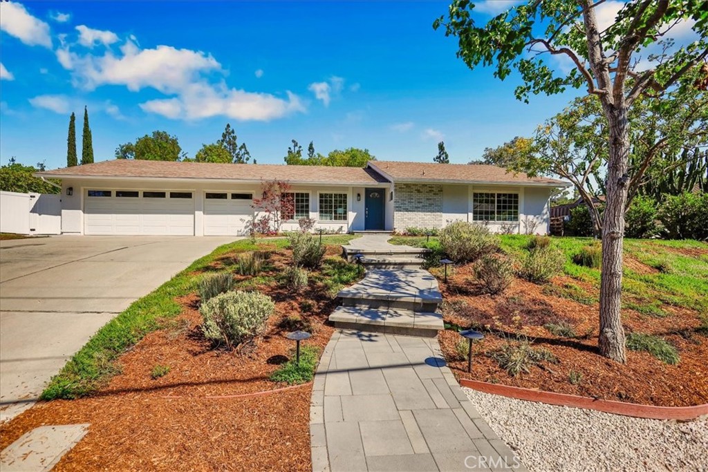 Welcome to your own private oasis in Fullerton! This beautifully maintained 4-bedroom, 2-bathroom home offers 1,626 square feet of comfortable living space. Step into a spacious living room filled with natural light, thanks to large windows that create an airy, open feel. The galley-style kitchen is both stylish and functional, featuring white shaker cabinets, granite countertops, a travertine subway tile backsplash, recessed lighting, and ample storage. A convenient breakfast bar connects the space, perfect for casual meals or morning coffee. Just off the kitchen, the dining room boasts a wrought iron chandelier, large windows, and a cozy fireplace — all overlooking and offering access to the expansive backyard. The generously sized primary suite is a relaxing retreat, with its own ensuite bathroom featuring a large vanity, storage cabinet, and a private room with a standing shower and toilet. Additional bedrooms are comfortably sized and carpeted. Step outside to enjoy the ultimate backyard escape! The oversized yard features newer paver hardscaping, a sparkling pool and Jacuzzi, and multiple areas for entertaining — including a shaded patio cover, outdoor kitchen island with built-in BBQ, single burner, dual-drawer refrigerator, bar seating, and plenty of cabinet storage. A grassy area offers space for pets or play. Rounding out the home is a spacious 3-car garage, with one bay converted into a functional storage area complete with built-in cabinets and carpeted flooring , ideal for a workshop, gym, or hobby space. Located near Hillcrest Park and just minutes from vibrant shopping, dining, and entertainment, this home is also situated in the highly desirable Beechwood School K-8 and Fullerton Joint Union High School. Don’t miss your opportunity to own this exceptional home!