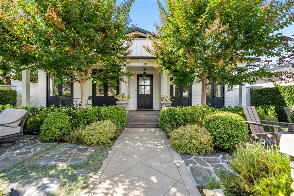 Tucked within the highly sought-after neighborhood of Newport Heights, this single-level coastal residence blends timeless character with modern sophistication. Thoughtfully remodeled, the home offers 3 bedrooms, 3.5 baths, and 2,048 square feet of beautifully designed living space, anchored by clean architectural lines, curated finishes, and a seamless connection to the outdoors. Inside, the light-filled interiors showcase wide-plank oak flooring, custom millwork, and an open layout that exudes both warmth and refinement. The chef’s kitchen is a centerpiece of the home, featuring black stone counters, a La Cornue-inspired range, glass-front cabinetry, and a farmhouse sink—all opening effortlessly to the spacious living and dining areas. The primary suite is a serene retreat with garden views, a luxurious marble-clad bath, soaking tub, and walk-in shower. Two additional bedrooms, each en suite, provide comfort and privacy for family or guests. A dedicated home office nook and thoughtfully placed windows bring natural light into every corner. Outdoors, the property is equally captivating. The front garden is a private oasis with mature trees, stone pathways, and inviting seating areas—ideal for relaxed evenings by the fire pit. The backyard is designed for year-round entertaining, complete with a sparkling pool, built-in BBQ, shaded dining patio, and alley access leading to a two-car garage. Set just moments from Cliff Drive Park, world-class beaches, award-winning schools, and the shops and restaurants of 17th Street, Lido Village, and Westcliff Court, this home captures the essence of Newport Heights living—classic, coastal, and undeniably refined.