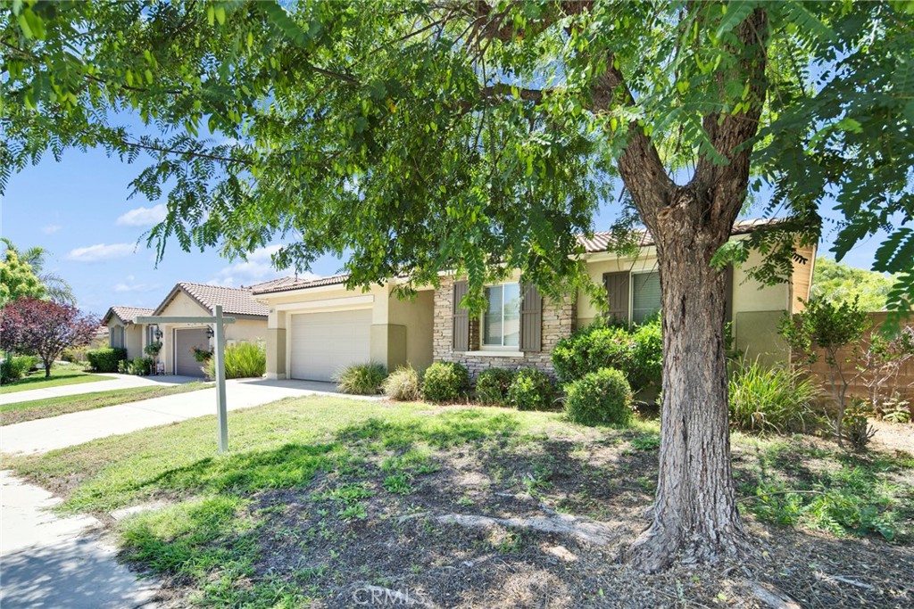 Welcome to this rare Single-Story beauty in Rolling Hills. Located in the highly sought-after Rolling Hills community. This beautifully maintained 3-bedroom, 2-bathroom Menifee gem offers 1,946 square feet of comfortable living with a layout that’s as functional as it is inviting. The open floor plan is perfect for entertaining, with a spacious living area that flows seamlessly into the dining space and kitchen. Step inside to find an open-concept living space filled with natural light, ideal for both relaxing and entertaining. The open-concept layout is bright and welcoming, with rich laminate wood flooring guiding you from the entryway through the kitchen and hallway. At the heart of it all is a chef-inspired kitchen—featuring stainless steel appliances, granite countertops, a spacious island. The kitchen flows effortlessly into the dining area and expansive great room, creating the ideal setting for connection, comfort, and celebration. When it’s time to unwind, retreat to your private primary suite—your own sanctuary complete with a walk-in closet, dual sinks, a step-in shower, and a spa-worthy oversized soaking tub. Two additional bedrooms are perfect for family, guests, or a home office. Step outside and discover your private backyard oasis—lush green lawn, colorful flower beds, and stamped concrete patio.The low-maintenance front yard and extended driveway add curb appeal and practicality. Located in a friendly neighborhood with easy access to freeways, schools, shopping, dining, this home has everything you need. Do not miss out this move in ready love home.