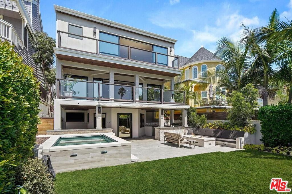 Experience the pinnacle of upscale beachside living in this stunning contemporary canal front residence. Featuring 4 spacious bedrooms and 7 elegantly appointed bathrooms. This architectural gem showcases impeccable designer finishes throughout. Step into your own private resort style sanctuary with expansive balconies on every level, offering seamless indoor outdoor living. The ground floor welcomes you with a large bonus room that opens to one of the most private and oversized yards in the neighborhood, complete with a built in BBQ, cozy fire pit, and a heated pool/spa, perfect for hosting unforgettable gatherings. The main level boasts a chef's kitchen outfitted with premium stainless steel appliances, sleek custom cabinetry, and generous counter space. An open concept layout flows into a sun drenched living area with floor to ceiling glass doors, providing captivating views of the canal and embracing the essence of California living. Retreat to the luxurious primary suite featuring panoramic canal views, a massive walk in wardrobe closet, and dual en-suite bathrooms. Each of the three guest bedrooms is generously sized and includes its own private bathrooms. Ascend to the rooftop deck for breathtaking sunset views, dazzling firework displays, or peaceful nights under the stars. The attached garage accommodates up to four vehicles, and the home is ideally situated adjacent to the picturesque canal path, just minutes from the beach, top tier dining, and boutique shopping.