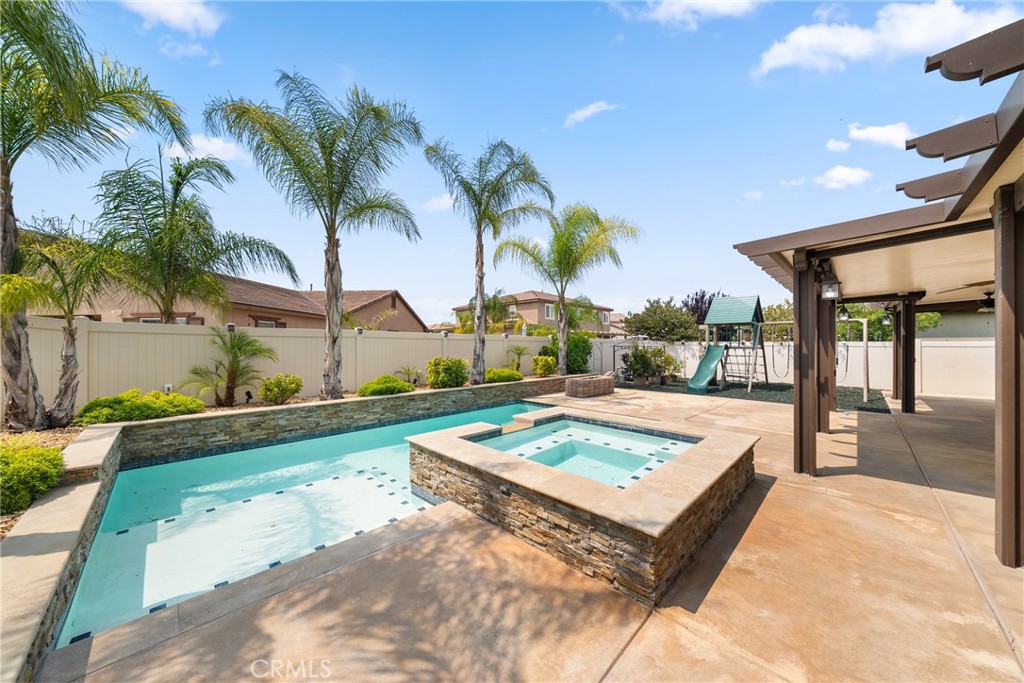 NO HOA, LOW TAXES, and PAID OFF SOLAR! If you’re looking for space, luxury, and location, this stunning POOL HOME in Menifee truly has it all! With approximately 3,794 sq. ft. of living space on a nearly 9,600 sq. ft. lot, this 5-bedroom, 4-bathroom home includes a main floor junior suite with a 3-car garage. Inside, you'll love the beautifully appointed layout featuring a formal dining room, an expansive gourmet kitchen with a center island, stainless steel appliances, GE Profile trash compactor & dishwasher, and a walk-in pantry, all open to the family room—perfect for entertaining. Throughout the main level, you'll find plantation shutters, crown molding, 5" baseboards, and professionally tinted sun-facing windows for added energy efficiency. Upstairs features a spacious loft, upstairs laundry room, and generously sized bedrooms. The primary suite offers comfort and luxury, while the whole house fan, dual-zone A/C, and ceiling fans throughout ensure year-round comfort. Additional upgrades include an Instahot water system with integrated reverse osmosis, and a 4-camera security system with two-way video doorbell for added peace of mind. Step outside to your private backyard oasis with Alumawood patio cover and ceiling fans, a sparkling pool and spa, and a natural gas fire pit with stunning fire glass—perfect for enjoying warm Menifee evenings with friends and family. Located just minutes from Menifee Countryside Marketplace, Menifee Town Center, and the popular Mount San Jacinto College campus, you'll find shopping, dining, and entertainment at your fingertips. Plus, you're a short drive to Temecula Wine Country, Diamond Valley Lake, and local golf courses, giving you plenty to explore on the weekends. This home is better than new—upgraded, energy-efficient, and move-in ready! Don’t miss your chance to own one of Menifee’s best homes. Schedule your private showing today!