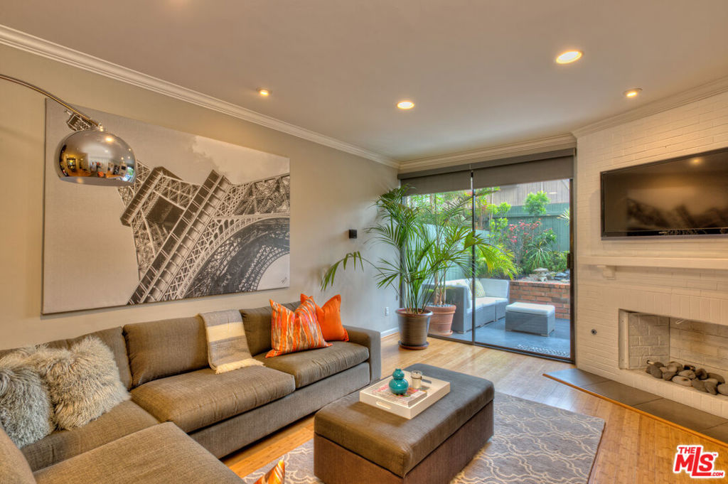 This beautifully renovated end-unit townhome combines comfort, style, and convenience across 1,600+ SF of living space. The 2BR/2.5BA layout features an inviting open floor plan, bamboo flooring, an upgraded kitchen, and modernized bathrooms. Natural light fills the living area, which opens to a serene west-facing patio. Upstairs, the primary suite offers a private balcony, spa-inspired bath, and thoughtfully designed custom closets. A large walk-in closet and generous storage throughout make organization effortless. Community amenities include a well-equipped fitness center, sparkling pool, spa, and secure gated access with camera monitoring. Tucked away from street noise, this home offers peace and privacy while remaining close to Ocean Park Blvd's coffee spots and restaurants, plus quick access to the 10 Freeway and Expo line. Side-by-side parking included.