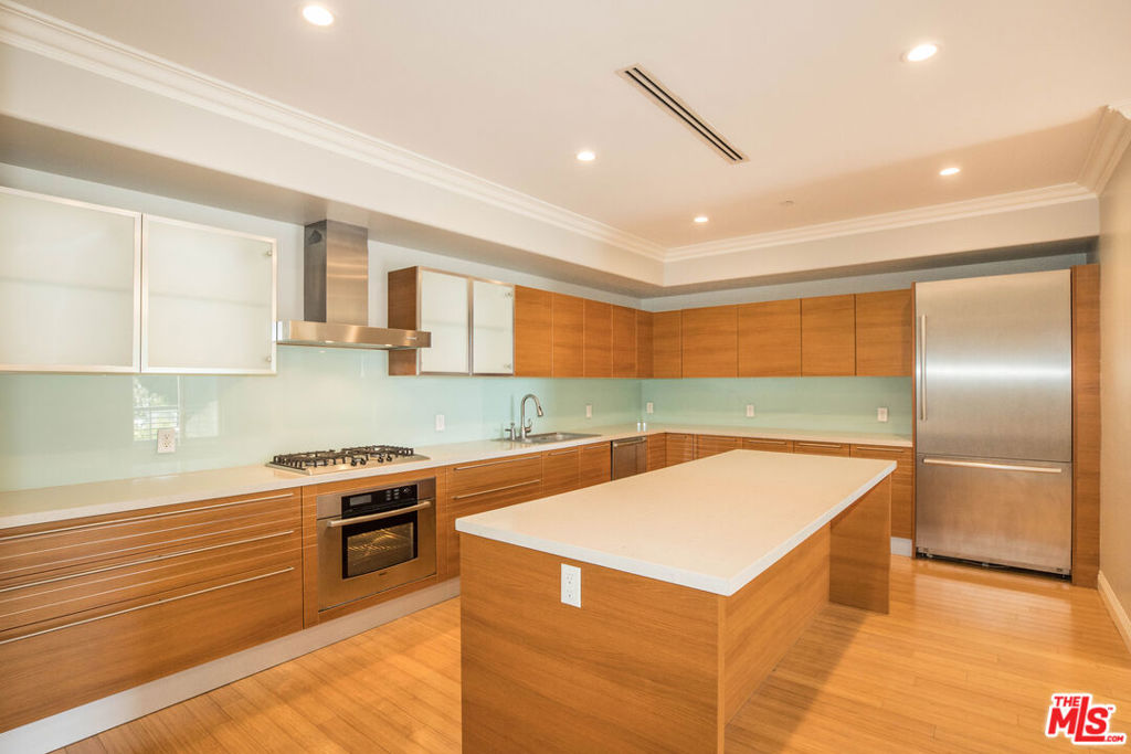 Experience contemporary luxury in the heart of West Hollywood. Located in a premier building originally constructed as a condominium, this refined residence offers exceptional quality and thoughtful design throughout. Encompassing approximately 1,480 square feet, the unit features three generously sized bedroom with ample closet space, hardwood floors, soaring ceilings, and recessed lighting. The spacious living room includes a cozy fireplace and opens to a wraparound balcony, perfect for indoor-outdoor living. A modern chef's kitchen is equipped with premium Bosch stainless steel appliances and expansive counter space ideal for both daily use and entertaining. Additional highlights include two elegantly appointed bathrooms, in-unit washer and dryer, a second private balcony, and a dedicated private storage room located in the garage. Residents enjoy access to a rooftop deck with sweeping 360-degree views of the city and surrounding mountains. Situated just moments from Sunset Boulevard, this prime location places you near West Hollywood's top restaurants, boutiques, and vibrant nightlife. 12+ lease term.