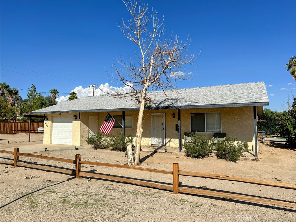 Adorable 1 bedroom 1 bathroom corner lot home in the Chocolate Drop neighborhood of 29 Palms! This home features upgrades throughout. The open concept interior design boasts a large kitchen peninsula and cozy living room. Central heating and air, a swamp cooler, and ceiling fans ensure comfort throughout the year. The front porch is perfectly located to enjoy evening sunsets and incredible mountain views. Plenty of parking including an attached 1 car garage and metal carport. Wood split rail fencing lines the property boundaries. Currently a long term rental. Short drive to the North entrance to Joshua Tree National Park. The central location makes this a fantastic opportunity for a starter, retirement, or rental home!
