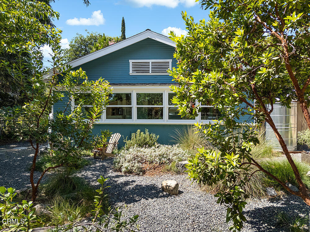 In tree-lined Northwest Pasadena, this stylishly updated home is a real estate unicorn: a light-filled Craftsman that feels both warm AND bright. Secluded behind oaks, agaves and a stately Mulberry tree, the artfully designed gardens here are both beautiful and sustainable with greywater irrigation. Follow flagstone steps on a permeable granite front path to find classic clapboard siding, elephantine column bases and solid 8-light front door with contemporary wood steps that marry modern organic stylings of the garden with the classic architectural elements of this special home. Inside, the front entry with its ribbon of double-hung sash windows and built-in window seat bench is inviting and practical for modern living. A generous living room, with coved ceilings, decorative stacked brick fireplace and dual-pane casement windows, also accomodates formal dining. The floorplan flows well here, with the sunny breakfast room and remodeled kitchen to the south, and private spaces to the north. Kitchen features marble subway tile backsplash, stone counters, stainless steel appliances and ample storage. A farmhouse sink with a leafy green view and Dutch door opening to the backyard dining deck make for happy everyday vibes. Bedrooms and baths are updated and relaxed, each bedroom enjoying its own bonus feature: access to the sunny north deck and garden; en-suite bath; or pretty views - the mountain vista from upstairs is great. The spacious primary suite with dual-sink marble vanity and rainhead shower is elegant and comfortable, but the spacious attached laundry may be the icing on the cake! Outside, gardens are private and shady with fragrant shrubs and native grasses, a sculptural tree aloe and split tree-trunk benches offering a spot for gathering. A heated plunge pool spa with sunning deck is ideal for quiet relaxation or morning yoga. Lastly, the one car garage with built-in workbench is a ready workshop, studio - the potential is endless. Located minutes from the buzzing Lincoln Avenue corridor (ice cream at Perry's Joint or the patio at Good Neighbor Bar!), Altadena's Christmas Tree Lane (the lighting this year is December 6!) and 10 minutes to the heart of old town Pasadena, this is a gorgeous property in a great location.