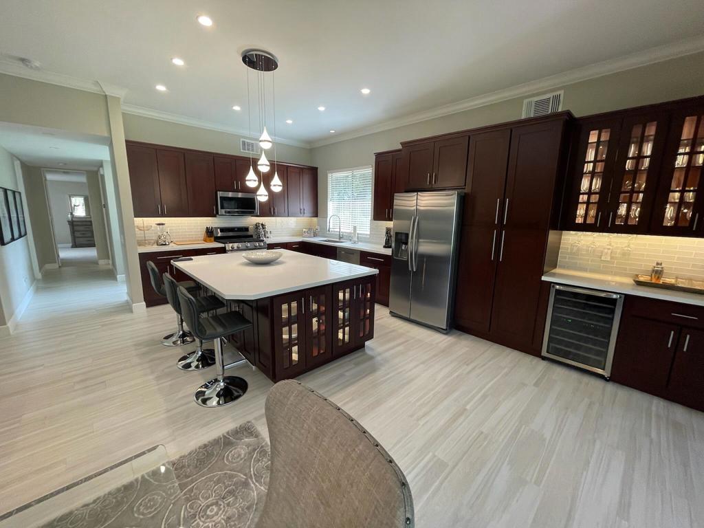 A beautifully remodeled and furnished 2 BR, 2.5 BA condo in IWCC. This floor plan is ideal, with a spacious kitchen/family room that opens to the covered patio and views of the community pool. A small office is located just off the patio for quiet reading space or those Zoom meetings. Both bedrooms have ensuite baths plus a powder room for guests. Each suite is separate from the other for quiet privacy. The kitchen has a wine refrigerator, wood cabinets, stainless appliances and an island with seating. Located across from the IW Tennis Garden, this is a prime spot with easy access to dining, grocery shopping and outdoor recreation. Detached 2-car garage. Located inside the guard-gated IWCC, this is the perfect location! Owner will consider 6 month lease term for $7,500/month. Tenant pays all utilities.