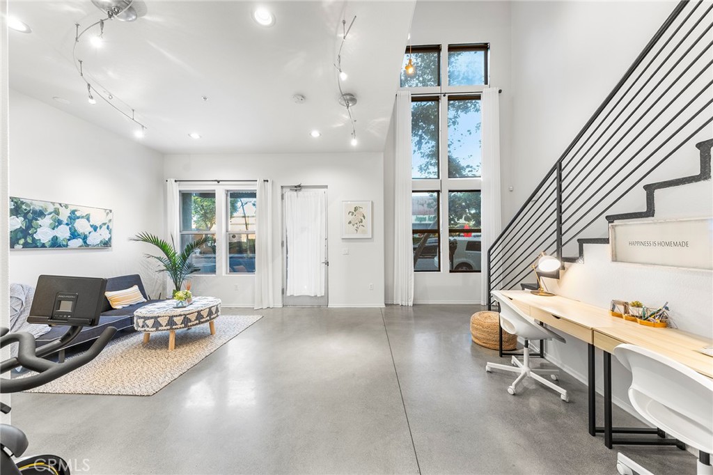 THIS IS THE LOFT YOU HAVE BEEN DREAMING OF!!! The Artist Walk Lofts are ideal for your living/office needs in Historic Downtown Santa Ana. Welcome to this Trendy home packed with High Quality Upgrades within walking distance to the most desirable California Top 10 High School - Orange County School of Arts. Steps through the front door and enjoy all this outstanding home has to offer. Soaring Ceilings in the main floor. Enormous Dual Pane Windows that Offer Lots of Natural Light, Polished Concrete Flooring, Custom roller Blinds, Exposed Duct Work, Designer Industrial-Style Fixtures & Accents, Recessed Lighting, Ceiling Fans, Newer Interior Paint, It Includes a Large Downstairs Studio or Living Room and Oversized Remodeled Bathroom, Plus Direct Access to Very Rare TWO-CAR "Finished" Garage with Storage Spaces.
Upstairs You'll Find Open Concept Living Areas that Includes Living Room, Dining Room, The Remodeled Gourmet Kitchen with Island Boasts Quartz Countertops, Newly Stainless Appliances (Dish Washer, Stove, Microwave), Stainless Sink, and Newly water heater.
Upgraded Full Bathroom with Quartz Countertops, newly bathtub and Dual Sinks. Open Bedroom Niches which can be Fully Enclosed. Sliding Glass Door that Opens to a Lovely Balcony.
Walking Distance to California TOP 10 High School OCSA -Orange Country School of the Arts.
Enjoy Nationally Recognized Restaurants & Museums & More! SCHOOL - WORK - LIVE - PLAY in DTSA!