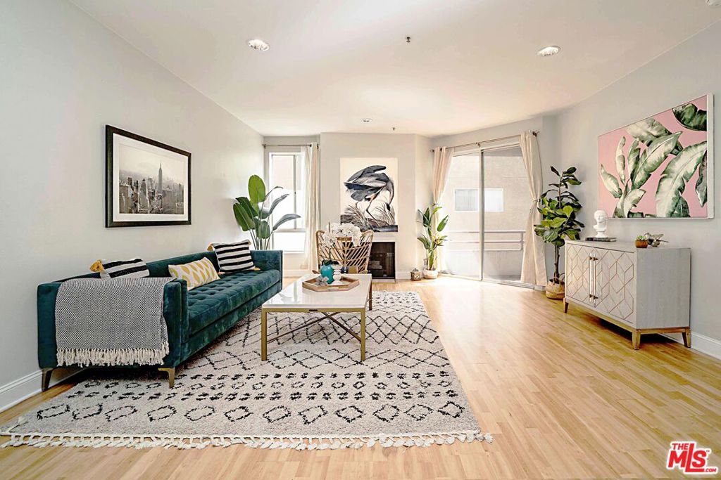 Modern Living in the Heart of KoreatownStep into comfort, style, and convenience with this beautifully updated 1-bedroom condo nestled in the vibrant heart of Koreatown. Located in the sought-after Wellington Residential, this home offers a perfect blend of contemporary design and urban accessibility.Inside, you'll find a spacious living room warmed by a cozy fireplace the perfect spot for relaxing evenings. The open-concept layout flows effortlessly into a dining area, ideal for hosting or enjoying quiet meals at home. The bright, modern kitchen is equipped with brand-new appliances, including a stove and refrigerator, ready to bring your culinary creations to life.Freshly painted and featuring new wood flooring throughout, the entire unit feels fresh, clean, and move-in ready. Sliding glass doors lead from the living room to a private balcony a peaceful retreat to enjoy your morning coffee or evening breeze.The generously sized bedroom offers a second access to the outdoor patio, inviting in natural light and fresh air. Storage won't be a concern here, with ample closet space throughout, plus TWO tandem garage parking spaces included.The building itself features a well-maintained lobby that provides a warm and welcoming entrance for you and your guests. Plus, low HOA dues make this home as practical as it is appealing.Located just blocks from Koreatown's best amenities, you'll enjoy easy access to local hotspots like Document Coffee, California Market, Park's BBQ, and Break Room 86. Whether you're dining, shopping, or exploring the nightlife, everything you need is just around the corner.Don't miss this rare opportunity to own a stylish, move-in ready condo in one of LA's most dynamic neighborhoods.