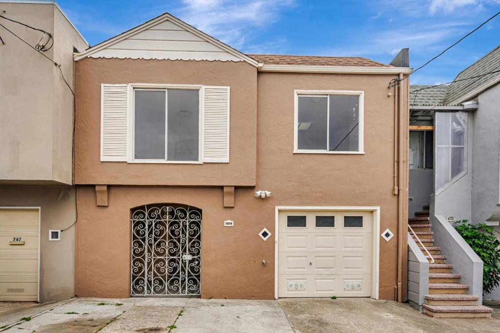 Classic San Francisco charm with good bones in Visitacion Valley. Nicely maintained and freshly painted, this well-lit home with 3 Skylights presents an honest canvas for buyers who appreciate original detail and potential. The upper living level enjoys warm hardwood floors, built-in shelving and arched openings that give the home character and flow. An eat-in kitchen retains its original stained wood cabinetry, serviceable layout ready for your personalization. The lower level offers a flexible bonus room, a convenient full bathroom and direct access to the garage and rear yard. Step outside from the covered rear deck to a secluded backyard with mature trees. Located close to Leland Avenue shops and eateries, McLaren Park, and with easy access to Muni, BART connections and US-101 / I-280, this is an appealing entry to San Francisco ownership.