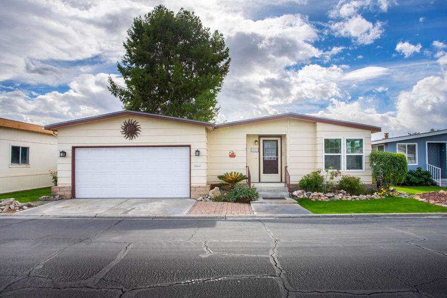 Fantastic opportunity to own in this prestigious senior gated community called desert sands. This is a good sized home with 1340 square feet of living space. Inside this home is drywalled and has laminate flooring throughout. Windows and doors are dual paned. Inside door are six paneled. Perfect location with no one behind except outstanding views of the southern and western mountains. This home comes with a galley kitchen, master bath with tub and shower, master walk-in closet, laundry room and a direct access two car garage. This home would be a great home away from home or a full time residence. Desert Sands has amenities including: Pool and Spa, Tennis, Clubhouse, Exercise room, Sauna, pool tables, and crafts room. This community looks like a regular tract of homes, all homes have two car garages. Space rent for new buyers is 925 per month.