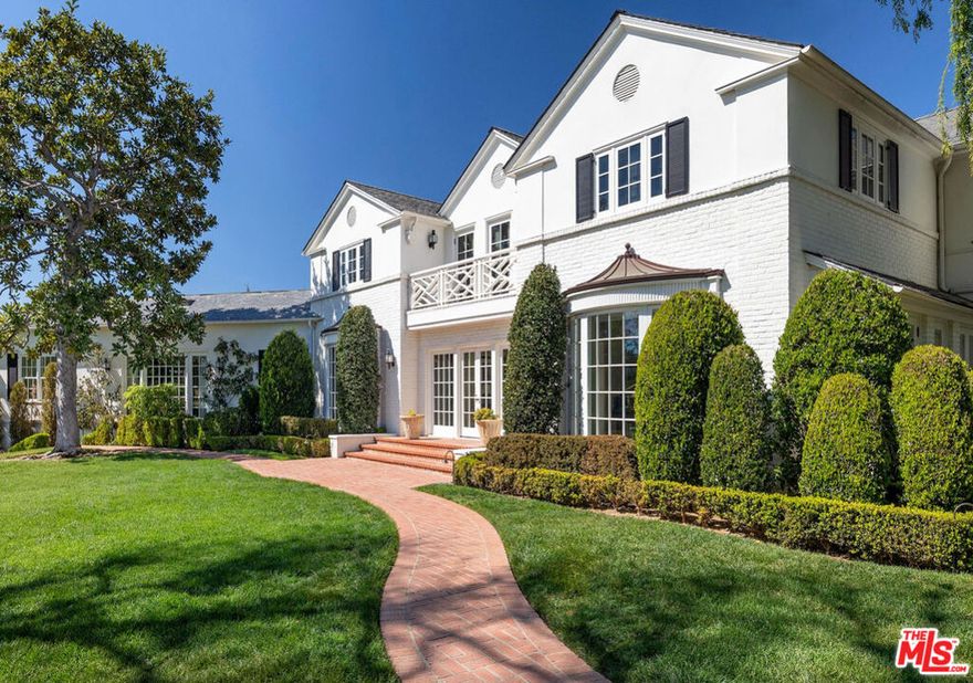 Legendary Holmby Hills estate designed by Paul Williams and featured in Architectural Digest. Glamorous and sophisticated, this incredible estate is completely remodeled and restored with meticulous detail and quality. Situated behind gates and up a long private driveway on almost 1.4 acres of lush privacy, manicured grounds, spectacular rolling lawns, sun drenched swimming pool, and a lighted  N/S tennis court. Magnificent 2-story oval entry with sweeping staircase, formal dining room, office, game room, and a stunning "Old Hollywood" art deco bar. The perfect flow for entertaining leads to a state-of-the-art screening room, large living room, luxurious family room, gourmet kitchen, and glass conservatory all with the perfect flow for entertaining. Featuring an incredible primary suite with the most glamorous dual baths and closets in the city.  There are 7 bedrooms in total (including guest house and staff). One of the most elegant estates fit for the most discerning. Priced to sell.