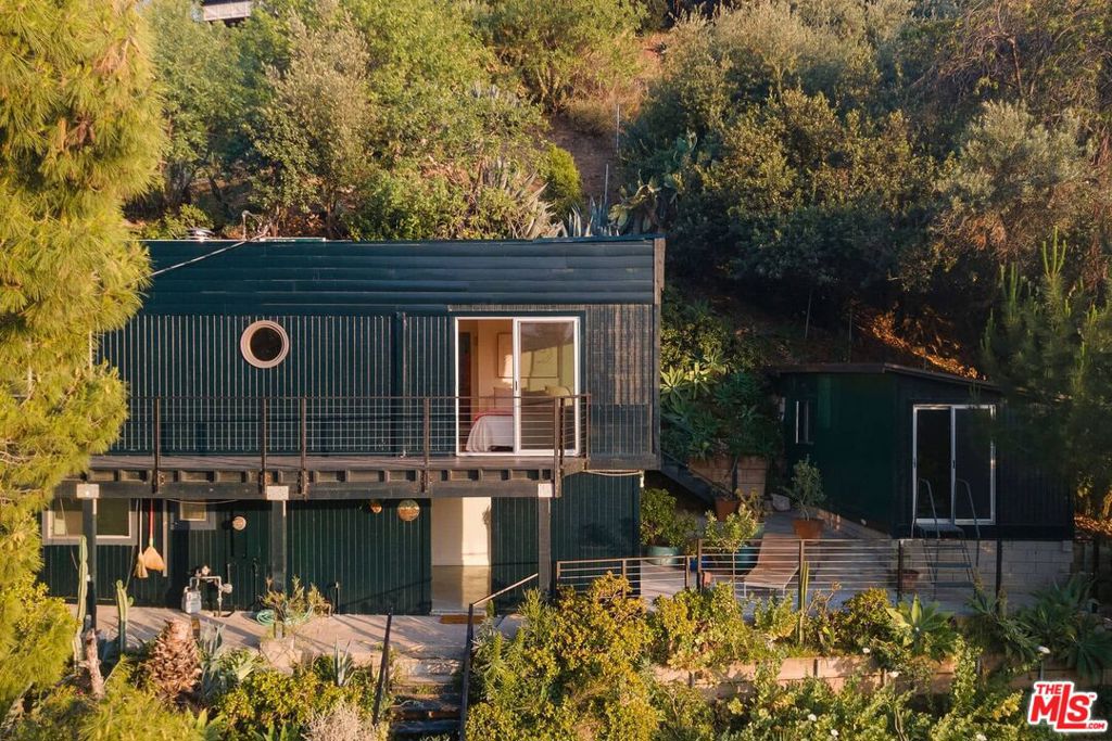 Perched atop a Mount Washington sun-dappled hillside, this one-of-a-kind rustic compound offers a rare blend of wild serenity and artistic soul, all just minutes from the buzz of Downtown Los Angeles. Set on 3/4 acre of land, this sanctuary features decades-old intentional protective coverings of fire-resistant succulents and drought-tolerant plantings. It is a true celebration of simple, soulful living, with panoramic vistas, hidden gardens, and meandering paths that invite you to wander, plant, and dream. The main house is an inspired fusion of mid-century design and woodland charm, where indoor and outdoor living intertwine effortlessly. Open-concept living, dining, and kitchen areas spill out onto expansive decks with sweeping views for alfresco meals, stargazing, or morning tea among the trees. The main bedroom sliding glass doors open to a deck, perfectly positioned to soak in golden-hour sunsets over the hills. A full bath completes this airy level. Down the spiral staircase, a finished lower level offers limitless potential, once home to potters, musicians, and globe-trotting guests. A bath, plus two versatile rooms, invite you to create, host, or simply unwind. Step outside and let the garden paths lead you to a yoga and meditation studio, an impeccably styled Airstream for glamping getaways, and an eco-conscious outhouse featuring a tub and shower.Fruit trees line the winding paths. Raised garden beds stand ready for seasonal harvests. A vacant chicken coop and beehives wait to be restocked and brought to life again. Here, the land speaks, inviting you to grow, gather, and ground yourself. Above the three-bay garage is a charming 642 sq. ft. one-bedroom, one-bathroom home with a garden deck, generating a steady income stream from a happy tenant. Tucked away yet just moments from beloved neighborhood Elyria Canyon Park trail, cafes, shops, and cultural gems, plus easy access to DTLA, Highland Park, and major freeways. If you've been craving space to breathe, farm, create, and still make it to your morning meeting downtown, this is your place. Come walk the land. Feel the stillness. Discover your hillside muse. (Past income breakdown: Main house 3130 Isabel $3750/mo,3128 Isabel $2,500/mo, Airstream income avg $1,200-$1,600/mo. Main house and airstream are now vacant).