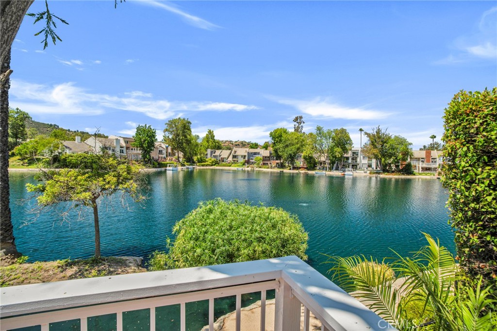 Enjoy serene lakefront living in this beautifully updated 3-bedroom, 2.5-bathroom townhouse, perfectly positioned to capture breathtaking water views from the moment you walk through the door. Step inside to discover soaring smooth vaulted ceilings and brand-new flooring throughout. The spacious living and dining rooms are bathed in natural light and offer expansive views of the lake. Just off the living room, step out onto the private deck—an ideal spot for morning coffee or evening relaxation—as you take in the tranquil scenery. With direct access to the lake and the scenic walking path, outdoor living is just steps away. The remodeled kitchen features sleek new countertops, stainless steel appliances, and ample cabinetry—perfect for any home chef. Adjacent to the kitchen, you'll find a cozy den, a stylish powder room, and a laundry room with direct access to the attached two-car garage, which has been upgraded with epoxy flooring and finished walls. Upstairs, the spacious primary suite is a true retreat, complete with stunning lake views from your private balcony, two closets, and a remodeled en-suite bathroom. Two additional bedrooms share a modernized bathroom with a double sink vanity. Additional upstairs highlights include a front-facing balcony, an interior landing balcony, and a large walk-in storage closet. Other home upgrades include: New HVAC, Electric Panel and garage door opener. Located just minutes from the Calabasas Tennis & Swim Center, The Commons, and the charming boutiques and restaurants of Old Town Calabasas, this home combines natural beauty with unbeatable convenience.