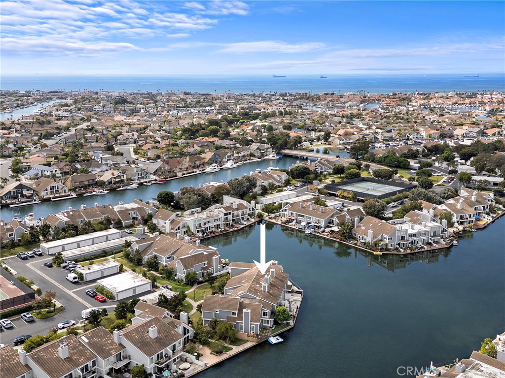 Set against the pristine lagoon of Huntington Harbour, this beautifully renovated three-bedroom, two and a half bath townhome in Seagate offers the ultimate waterfront lifestyle. Launch your kayak from your private patio and enjoy breathtaking sunsets. Inside, coastal charm meets modern upgrades: luxury vinyl plank flooring, recessed lighting, fresh paint, and a brand-new kitchen with quartz countertops, custom cabinets, and stainless steel appliances. The sunken living room, featuring a striking fireplace, flows into a spacious dining area perfect for entertaining. Off the kitchen, a family room with a slider opens to the front courtyard patio. The waterfront living room downstairs and the primary suite upstairs offer stunning views, making each evening a retreat. As a Seagate resident, enjoy resort-style amenities: two heated pools, a spa, six tennis courts, pickleball, clubhouses, a private yacht club, green belts, playgrounds, and scenic walking paths just steps from your door. Living here, you're minutes from Trader Joes, the Bolsa Chica Wetlands, the beach, top restaurants, breweries and endless outdoor fun.