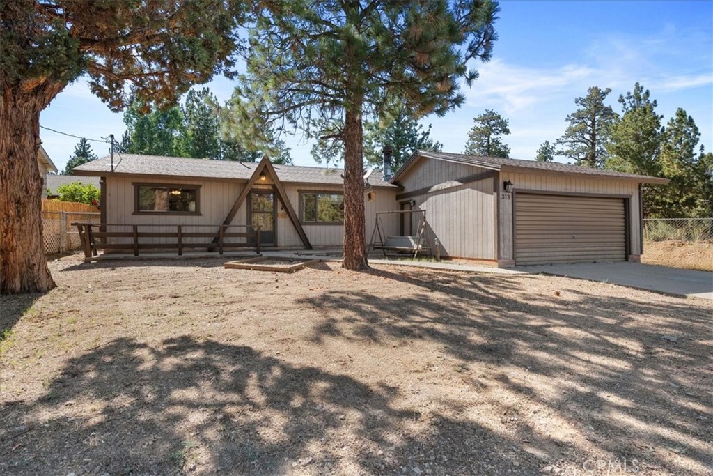 Welcome to your freshly updated Sierra-style cabin, a true gem! This inviting haven has undergone thoughtful renovations, featuring brand new laminated wood floors that provide a warm and welcoming atmosphere throughout. Fresh interior paint complements the cozy feel, while modern kitchen appliances and sleek countertops make this space not only functional but delightful for culinary adventures. The spacious living room boasts a stunning rock fireplace, for cozy evenings with loved ones after a day of exploring the great outdoors. The large family-style kitchen offers ample space for gathering, making it an ideal setting for creating lasting memories. This cabin features two generously sized bedrooms, each with abundant storage solutions, ensuring your personal effects are neatly tucked away. Step outside to discover your fenced backyard oasis, complete with a versatile shed for extra storage needs and flourishing fruit trees that bring a touch of nature's bounty to your doorstep. Set on a generous 6,600 square foot lot, this property is perfectly suited for a variety of lifestyles. Whether you’re looking for a full-time residence, an investment property for year-round rentals, or a second home getaway for unforgettable vacations, this cabin delivers.