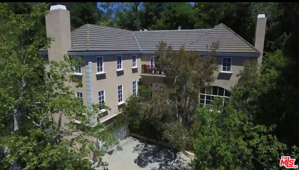 Tucked away on a quiet Brentwood street, this private three-story French Normandy residence blends timeless charm with thoughtful modern amenities; offering 6 Bedrooms, 6 bathrooms with 5,634 of living space on a spacious 16,412 square foot lot. Surrounded by mature oak and melaleuca trees, the home offers a rare sense of privacy while remaining minutes from the Brentwood Country Mart, Palisades Village, and easy freeway access. Through stately French doors, a dramatic foyer welcomes you into an interior of warmth and sophistication. The main level unfolds with a sun-filled formal living room anchored by a fireplace, an expansive formal dining room with versatile French door enclosures, and an inviting family room seamlessly connected to the kitchen. Designed with entertaining in mind, the chef's kitchen features stainless steel appliances, two built-in refrigerators, a wine cooler, and an oversized island with abundant counter space. A breakfast nook wrapped in windows and French doors bathes the space in natural light and opens directly to the patio. Upstairs, the luxurious primary suite boasts soaring cathedral ceilings, oversized windows, and a spa-inspired bath finished in quartz with gold accents. A soaking tub, walk-in shower, dual vanities, and private balcony overlooking the yard create a true retreat, complemented by a massive custom walk-in closet. Three additional spacious bedrooms and two full baths complete the upper level. The first floor offers flexibility with two additional bedrooms, a full and half bath, and a dedicated laundry room ideal for guests, staff, or home office needs. The backyard is an entertainer's dream, with multiple French doors leading to a generous patio with fireplace, while beyond lies a private pool and spa framed by lush landscaping. A built-in pergola houses a grill, second outdoor fireplace, and dining terrace, creating the perfect setting for alfresco living year-round. A rare opportunity to own a classic estate in one of the Westside's most desirable neighborhoods, this Brentwood home offers privacy, elegance, and exceptional livability. For Sale $8,450,000 For Lease $42,000 per month, furnished.