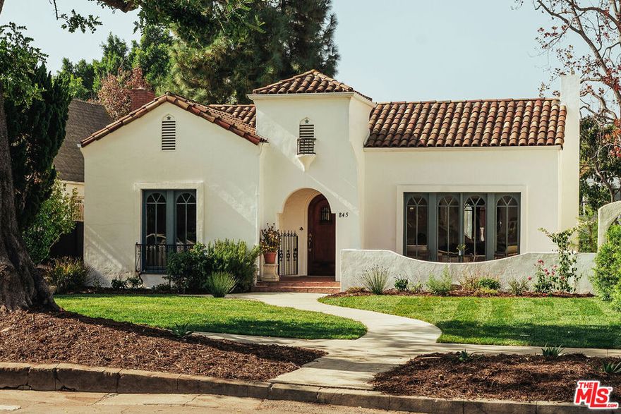 Step into this beautifully renovated Spanish-Moorish inspired architectural gem located in the coveted Brookside neighborhood of Los Angeles. With its enchanting combination of classic design and modern updates, this 3 Bed /2 Bath residence sits on an impressive 7303 sq foot lot, with a newly permitted, standalone ADU. Curved arches, intricate tile work, and high barreled ceilings capture the essence of Moorish design, blending elegance with warmth. Brand new gourmet kitchen serves as the heart of the home featuring custom inset cabinetry, quartz countertops, stainless-steel appliances, and a charming built in dining banquette, perfect for morning coffee or casual meals. Natural light floods the generous living and dining  areas through stunning arched wooden floor to ceiling windows. The luxurious primary bedroom offers a walk-in closet and ensuite bathroom with vintage-inspired tilework, plus French doors opening to an expansive outdoor deck ideal for ideal for alfresco dining and socializing.  The professionally landscaped grounds provide  multiple outdoor spaces surrounded by lush greenery, creating your own private California oasis. Sleekly designed ADU features LA Concrete Works cement floors,  a full kitchen with retro  refrigerator and microwave, room for washer/dryer combo unit, and spa inspired bathroom - perfect for generating rental income or housing guests and family.  Throughout the home, you'll find meticulously chosen finishes, including custom light fixtures, refinished hardwood floors, and modern hardware that pays homage to the home's distinctive architectural style. A California basement provides ample storage and solar panels make this home extra efficient .  Located minutes  to Larchmont Village and walking distance of Memorial Park.