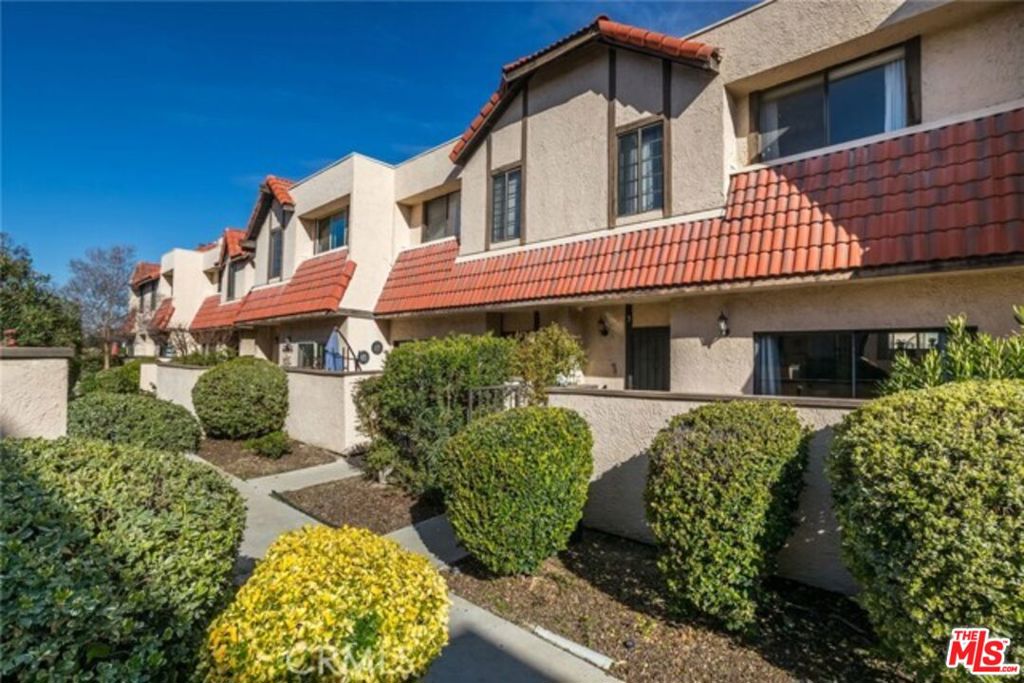 Welcome to this beautiful trilevel townhome, built in 1983 and ideally located in the desirable **Tres Robles Community**. Enjoy access to a sparkling swimming pool and secure recreation areas designed for relaxation, fun, and peace of mind. Step inside to discover a modern interior for maximum relaxation and enjoyment. The updated kitchen boasts sleek countertops, appliances including a double-door refrigerator, gas stove with hood, and dishwasher and is perfectly positioned next to a spacious dining area with gorgeous hardwood floors that flow seamlessly through the staircase, hallways, and bedrooms. The entry level welcomes you with a cozy family room complete with a fireplace and direct access to your private patio. A stylishly updated guest bathroom with tile floors and wall accents completes the lower level. Upstairs, you'll find two spacious bedrooms, each with hardwood floors and updated ensuite bathrooms. The primary suite includes a walk-in closet and a bath with a tub, while the second bedroom offers dual closets and a modern walk-in shower. Additional highlights include an attached two-car garage with laundry hookups, high ceilings with a statement hanging light fixture, and thoughtful upgrades throughout. This is modern living at its finest in the heart of Santa Clarita. Don't miss the opportunity to make this stunning townhome your own! Subject to Seller Replacement Home. (Buyer and/or Buyer Agent sole responsible for due diligence. Information herein is not verified nor purported as exact.)