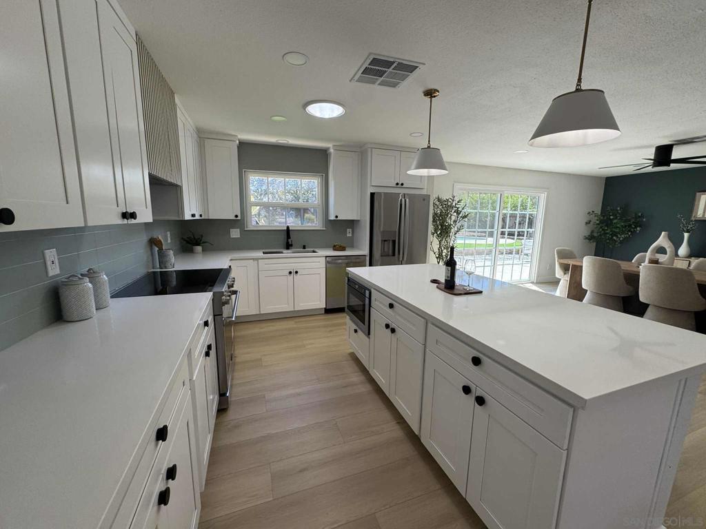 Welcome home to 2118 Toca Lane! Fully remodeled 3BR/2BA single level home on a quiet end-of-street location in Ramona’s desirable West End. The home has been fully updated with a new kitchen, remodeled bathrooms, reconfigured master suite, and new vinyl plank flooring, paint, lighting, and fixtures throughout. The brand new custom kitchen features quartz countertops, shaker-style cabinets, stainless steel appliances, a large island, and a custom hood. The dining area includes a feature accent wall and direct access to the backyard, fantastic for entertaining. The living room has a fireplace redesigned with modern tile, floating wood mantle, and an elevated hearth. The master suite was reconfigured to provide a walk-in closet and larger bathroom with dual vanity, walk-in shower, custom tile, and a designer backlit niche. Two additional bedrooms share a hall bath with double vanity, custom tile, and a matching backlit niche. Additional improvements include a newly resurfaced pool, all new landscaping with faux turf, and septic has been certified. The property offers an attached 2-car garage with laundry plus a detached 2-car workshop/garage with roll up door. The home is 100% electric and an excellent candidate for solar. Plenty of room to add ADU or potential for 1 horse (Zoned A70 with L Designator - buyer to verify). Convenient West End location close to town with direct access to the 67 for easy commute to San Diego! This home offers the perfect mix of country living with modern touches!