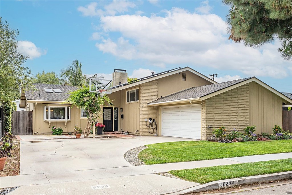 Discover this stunning tri-level home in coveted University Park Estates. This meticulously upgraded residence offers a blend of modern aesthetics, functionality, and comfort. Step inside to an inviting open-concept main floor plan featuring vaulted ceilings, new CALI natural hardwood flooring, a palette of designer paint, and striking mid-century modern lighting. The spacious living and dining areas are designed for gatherings, complemented by a cozy gas fireplace with a newly refurbished hearth. The space seamlessly transitions to a wonderful backyard, featuring a brand-new Pergolux motorized pergola with heater, a hot tub, built-in barbecue, and lush landscaping with fruit trees. Back inside, the living areas are open to the kitchen featuring custom cabinetry, stainless appliances including a Viking 6-burner range, solid-surface countertops, and a convenient eat-at counter. A stylish guest powder room completes the main level. A standout feature of this home is the expansive lower-level family room, offering a versatile space for both relaxing and entertainment, in addition to a newly constructed room that can serve as an office or guest area. The lower level is complete with a remodeled half-bath, laundry room, and extra storage. A modern staircase leads to the upper level with three bedrooms and two bathrooms. The primary suite has been elegantly remodeled to include an en-suite bathroom with an oversized shower, quartz countertops, and a spacious walk-in closet with California Closet organizers. Two additional bedrooms with a fourth remodeled bath completes the upper level. The home offers upgrades such as a new Bosch 5-ton AC with a heat pump, leased Sun Run solar panels with a Dual-Tesla Firewall, wired for a level-2 EV charger, LED recessed lighting, new overhead bedroom fans, a two-car garage, and a new sewer line/cleanout. This neighborhood offers access to award-winning schools, scenic bike paths, and a charming neighborhood park. It's conveniently located near the new PCH & 2nd shopping area, Naples, Belmont Shore, and the coast, providing array of restaurants, shopping, entertainment, and recreational activities. With its proximity to major freeways, this home ensures effortless connectivity to everything you need. Don't miss your chance to live in this exceptional home in wonderful University Park Estates!