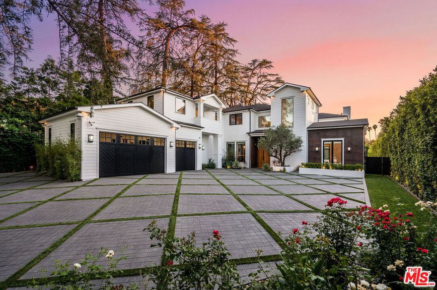 Modern Farmhouse Estate nestled privately South of the Blvd in Encino provides the ultimate luxury. 9864 sq. ft. of luxurious living space w/ 7 spacious bedrooms & 7.5 bathrooms. Grand entry boasts ultra high ceilings & checkered marble tile welcomes you to the dazzling dining room w/ brass built-ins & a formal living room with marble fireplace & private patio. European oak wood floors guide you to the sophisticated family room w/ marble slab fireplace & wooden built-ins. Across is gourmet chefs kitchen with two stone islands, Wolf & Sub Zero appliances, & breakfast nook. Opulent master retreat fts. a marble fireplace, custom built-ins, wine cooler, & spacious dual master bathrooms and closets. Backyard oasis is complete with an outdoor kitchen, bar, pool & spa, fire pit with built-in seating. Spacious guest house features 1,580 sqft 2 bed & 1 bath with family room & kitchenette. This unforgettable home is located just minutes from Ventura Blvd's trendy shops & fine dining.