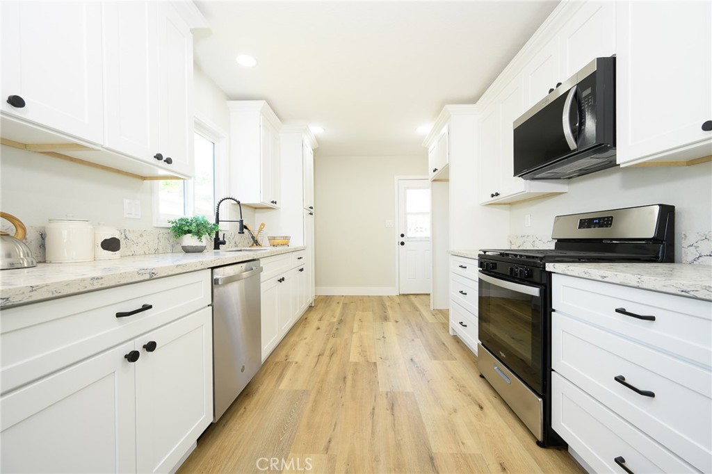 Stunning UPDATED 3 bedroom, 2-bathroom home in Pomona near lively downtown Pomona, shopping and close to freeways 71 and 10 for quick access. The kitchen features shaker-style cabinets with new quartz countertops, and stainless-steel appliances. The home has luxury flooring throughout the living areas and bedrooms, both bathrooms have new vanities, and custom tile work, freshly painted interior and exterior, split air and heat system for your everyday comfort, energy efficient windows, stylish lighting and plumbing fixtures throughout, and indoor laundry. There is ample parking and detached two car garage and spacious yard offers possible ADU potential. Buyer to verify all building codes and ADU guidelines with the city. Tax rolls show different bedroom and bathroom count.