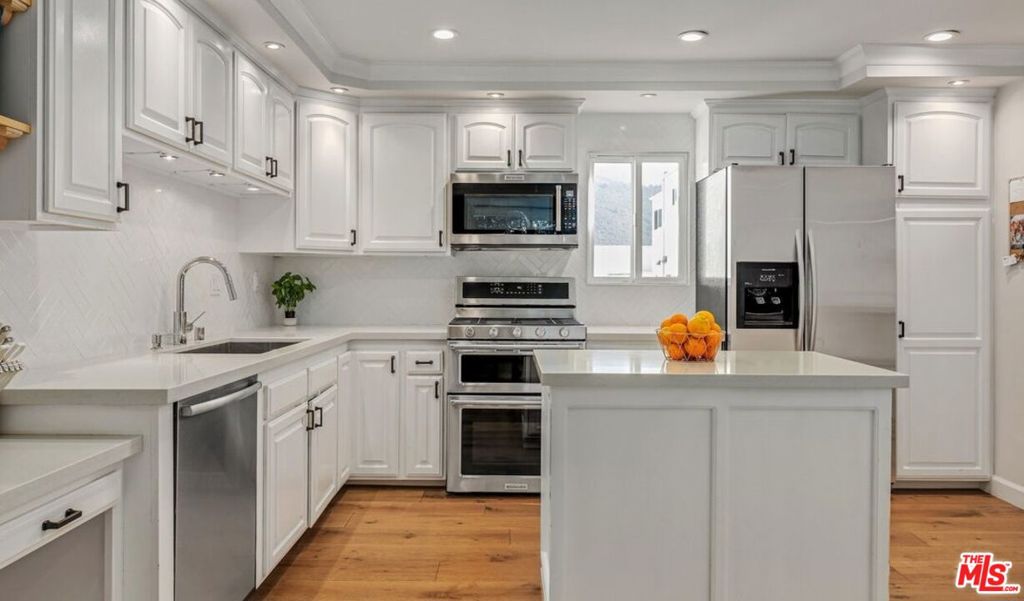 Beautifully remodeled townhouse located in The Highlands in Pacific Palisades. It features 3 bedrooms, 3 bathrooms and an open floor plan with wide-plank engineered hardwood floors throughout. The living room has a fireplace, high ceiling, and a large enclosed patio. The spacious open kitchen has quartz countertops, an island and breakfast bar with pass through to the Dining Area. The 3rd bedroom in on the main floor and can also be used as a den or office. The primary bedroom has an ensuite bathroom, walk-in closet and attached room that makes the perfect home office. The 2nd bedroom has a full ensuite bathroom. There is a private 2-car garage with direct entry, newer HVAC with Nest control. With an abundance of HOA amenities including tennis courts, swimming pool, spa, gym, sauna, and guest parking, this property truly offers it all. Owner pays for water. It has been remediated after the Palisades Fires and in fact, The Highlands did remarkably well after the fires, it appears as though there was never a fire.
