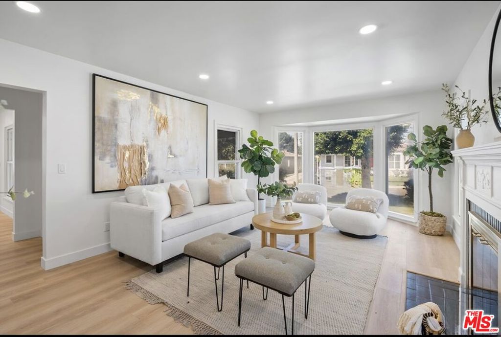 Mediterranean Charm Meets Modern Comfort in Prime Inglewood. Welcome to this beautifully updated Mediterranean-style retreat, perfectly situated on a wide, tree-lined street in one of Inglewood's most convenient neighborhoods. From the moment you step through the graceful front archways into the spacious patio, you'll feel right at home in this bright, open-concept beauty. Inside, soaring ceilings and abundant natural light create a warm and inviting atmosphere. The main living area is anchored by a cozy fireplace, ideal for both relaxing and entertaining. The remodeled kitchen is a showstopper, featuring sleek cabinetry, a waterfall-edge breakfast bar that opens into the generous dining space, a sunny breakfast nook, and a walk-through pantry. With three spacious bedrooms and stylishly renovated bathrooms, the layout offers comfort and flexibility. One bedroom has its own en-suite, while the oversized primary suite at the rear of the home features direct backyard access, a walk-in closet, and a spa-like bath with double vanity, soaking tub, and glass-enclosed shower. Additional features include a second living room or den, a separate laundry room, and a versatile bonus space near the rear entrance. Double-pane windows, smart mirrors, and quality finishes throughout add to the home's modern appeal. Outdoors, enjoy a private, low-maintenance backyard and a long driveway leading to a detached garage with extra room for storage. Located just minutes from SoFi Stadium, the Kia Forum, Intuit Dome, and LAX, with easy freeway access, this move-in-ready gem offers comfort, convenience, and style.
