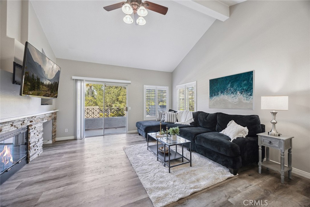 Nestled in the privately gated Viewpointe community, this property is in the most ideal location to take full advantage of the views, pool, parking and quiet hillside setting. Tucked discreetly within the neighborhood, this beautifully upgraded home offers the perfect blend of comfort, style, and desirable tranquility. Surrounded by lush grassy lawns and mature trees, the setting provides a peaceful, park-like ambiance. Step inside to find soothing neutral wall tones, wood-look flooring throughout the main living areas, new bedroom carpet and plantation shutters all enhancing the modern yet warm aesthetic. The updated kitchen is a standout, featuring crisp white shaker cabinetry, quartz countertops, full-height glass tile backsplash, open shelving, and stainless-steel appliances, all thoughtfully designed for both function and style. The living room boasts a striking stacked stone fireplace and opens to a private balcony, perfect for enjoying morning coffee or evening sunsets. Tall ceilings create an airy, spacious feel throughout the home. The primary suite includes a serene bedroom retreat and an updated en-suite bath with an oversized dual-headed shower, dual quartz vanity atop shaker cabinetry and desirable closet storage. The second bedroom features mirrored closet doors and ideally serves as home office, guest room or separate den. Convenient indoor laundry is tucked into a stackable washer/dryer closet space. Enjoy the HOA amenities, situated just a short stroll away … including a sparkling pool and spa, available barbecues with al fresco dining seating as well. Additional highlights include a private single-car garage, assigned covered parking space directly across from the home and plentiful guest parking. Moments to walking trails, shopping, schools, parks and freeway access. With its prime location and thoughtful upgrades, this home offers a rare opportunity to enjoy effortless living in one of the area's most sought-after communities.