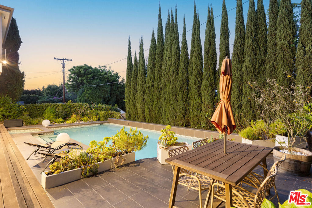Fully Furnished rental. This is located in Los Angeles School district / boarder of Beverly Hills/ Pico - Robertson Welcome to Beverly Green, an exquisite Los Angeles retreat located just five minutes from the iconic Rodeo Drive. This luxurious 3-bedroom, 3-bathroom home is the epitome of elegance and comfort, offering the perfect escape in the heart of Beverly Hills. Designed for extended stays, this property combines sophistication with functionality, ensuring a seamless experience for guests.The backyard is a private oasis surrounded by carefully planted trees that create a serene, high-end haven. Dive into the large pool or relax in the hot tub, both surrounded by stylish sun loungers and ample patio seating. Whether you're hosting a casual barbecue with the outdoor grill or enjoying al fresco dining under the umbrella-shaded table, this outdoor space is perfect for relaxation and entertaining.Step inside to find a bright and open interior, adorned with high-end furnishings and thoughtful design elements. The main living room flows effortlessly into a sophisticated dining area with seating for eight, making it ideal for hosting picture-perfect gatherings. The fully equipped kitchen is a chef's dream, complete with modern appliances, plenty of counter space, and a cozy breakfast nook that's perfect for casual mornings or late-night snacks.For added convenience, the lower-level living area offers additional seating and a one-of-a-kind desk setup, ideal for remote work or study while enjoying views of the pool. This home is designed to accommodate your entire group, with three comfortable bedrooms that provide a restful retreat. Two bedrooms feature king beds with private ensuite bathrooms, while the third includes a queen bed and access to a shared bathroom.Beverly Green also offers practical amenities to enhance your stay, including convenient driveway and garage parking, as well as an in-home laundry room. Every detail has been considered to provide you with a luxurious yet hassle-free experience.Immerse yourself in the ultimate Beverly Hills lifestyle, where prime location, group-friendly design, and premium amenities come together for an unforgettable stay.