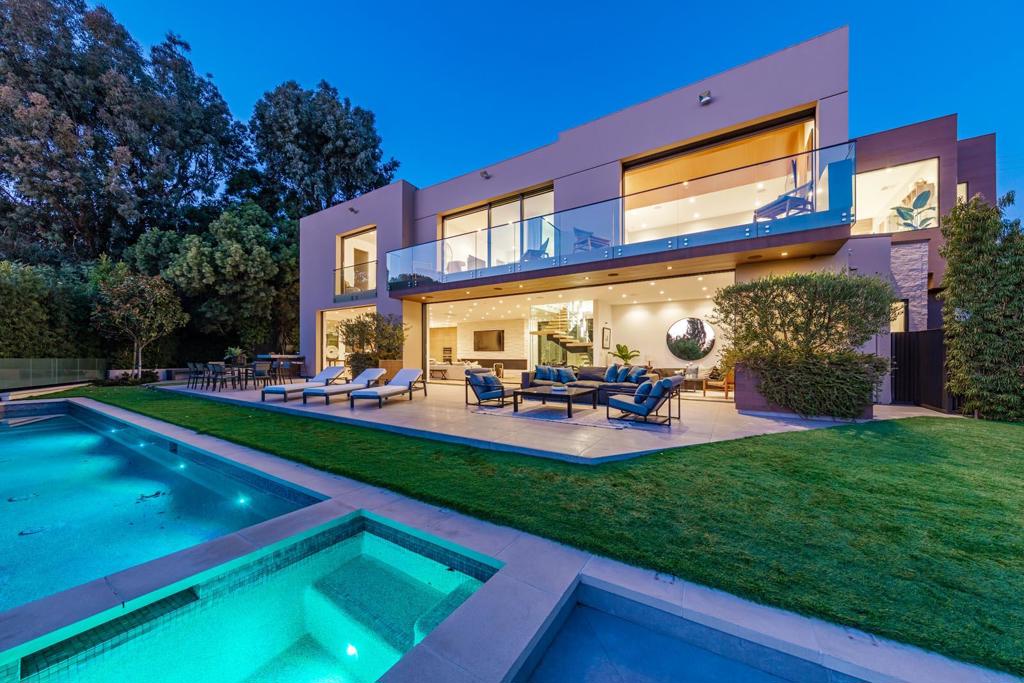This stunning three-story architectural masterpiece is located on one of the most prestigious streets in Los Angeles. The moment you enter the sweeping glass entryway, you're greeted with panoramic ocean views, which truly makes this home a prized property. The bright six-bedroom home is the epitome of California indoor/outdoor living, boasting sliding glass Fleetwood doors for direct access to the expansive backyard. The top of the line Chef's kitchen features Wolf and Sub Zero appliances, Dekton countertops, and Australian Oak cabinetry. The upper level holds four en-suite bedrooms, including a lavish master, with a grand walk-in closet and an oversized bathroom equipped with a steam shower and a stand-alone bathtub overlooking the ocean. The lower level features a state-of-the-art home theater, gym, fully illuminated onyx bar, temperature-controlled wine cellar, and a Crestron home automation system.