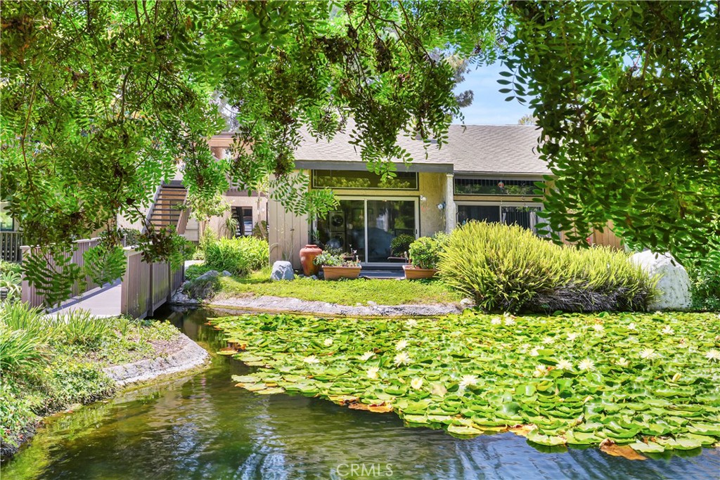 Welcome to this beautifully updated 1-bedroom, 1-bath loft style condo in the scenic El Dorado Lakes community in Long Beach. The thoughtfully designed open floor plan seamlessly connects the kitchen, dining area, and living room creating a cohesive and inviting living environment. The interior boasts warm earthy tones, smooth scraped ceilings, bullnosed corners, rustic tile flooring, an updated kitchen with distressed-white cabinetry, granite countertops, stainless steel appliances and a breakfast bar - perfect for cooking and entertaining. In the living room abundant natural light streams through the large, double-pane vinyl sliding door and transom window enhancing the overall ambiance. Pass through the sliding door to the private patio offering a tranquil space to enjoy the beautiful water view while savoring morning coffee or unwinding in the evening. The upper floor hosts a spacious bedroom and bathroom both upgraded with new carpet in the bedroom and tile floors in the bath. The inviting spa-like bath showcases stunning slate-like tile, complemented by granite countertops at the vanity. Adjacent to the bathroom is the large walk-in closet providing ample space for your personal items. In addition to the aesthetic upgrades practical improvements include: in-unit laundry hook-ups, a new dishwasher, new carpet in bedroom and on stairs, and a detached double-car garage just steps away from the unit. The El Dorado Lakes community itself is a picturesque complex offering a range of amenities such as two community pools, tennis courts, a clubhouse, and a fitness center. And of course, the gorgeous water features, abundant wildlife and greenery that make El Dorado Lakes sought after.