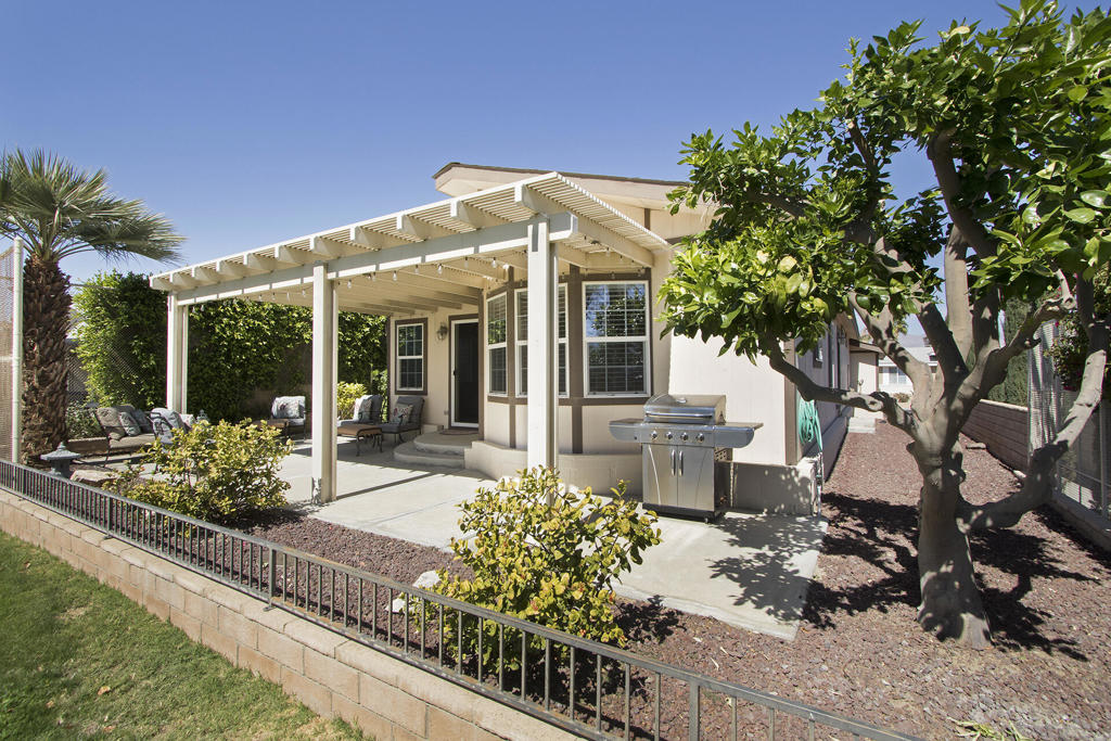 Announcing MAJOR price drop! Owners have returned to Canada permanently. Now available for tour daily 9 AM - 4 PM. Stunning views of the golf course and mountains from this beautiful south facing home located on the 5th fairway of Ivey Ranch CC golf course. Built in 2006it is over 1500 sq. ft with 3 bedrooms 2 bathrooms.The large covered fully furnished patio offers plenty of room for entertaining and relaxing; both slider and kitchen door open for easy access when grilling. Some furniture may be included.Master Bedroom with a large en suite bathroom and a walk in closet. Two additional bedrooms are spacious with close access to full hall bathroom.Granite counters with woodgrain cupboards in this roomy kitchen, direct access to dining area and opens to the living room. Vaulted ceiling, ceiling fans,includes updated appliances with separate laundry room.3 car attached garage easily holds 2 cars with a separate door for a golf cart.This home has a 433 Permanent Foundation for easy financing and you own the land. Ivey Ranch CC & GC, is a gated, senior community of manufactured homes integrated with a 9 hole golf course, Pro-shop, Driving Range, 4 community pools, exercise equipment room, tennis pickleball courts, 2 community spas, Club House and a Seasonal Restaurant. Many active socialclubs offer various activities.