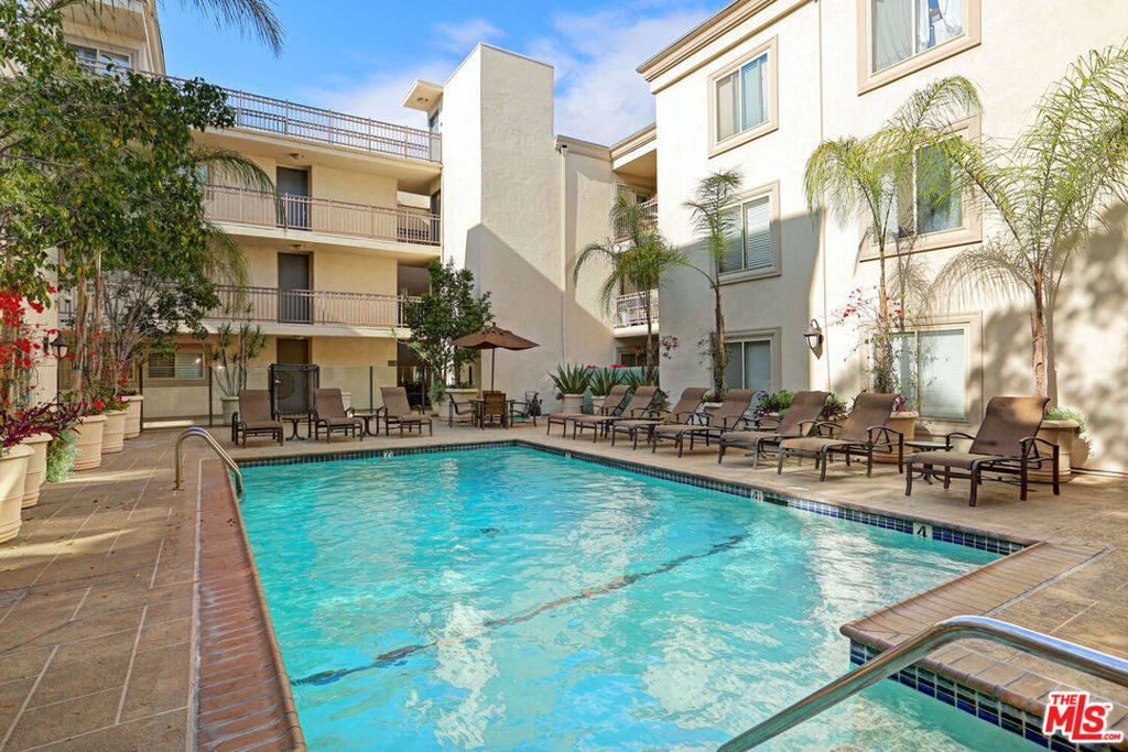 Amazing price! Wonderful opportunity to live in a fabulous location! This chic 1BR/1BA PLUS DEN has ample custom closet space, spacious den, fireplace, washer/dryer in the kitchen, balcony overlooking the courtyard, and TWO parking spaces. Beautifully fitted with stainless appliances, stone surfaces, wood floors, and glass-tiled shower. This prime oasis is located between Beverly Hills and West Hollywood. The highly sought after Rob Clark building is close to the boutiques and restaurants of Robertson. Outdoor area for your guests. Walk to restaurants, hotels, shopping and markets. Parks nearby. Gym in building, pool, laundry in unit.
