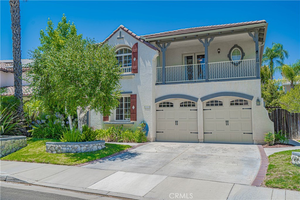 Situated at the peak of Stevenson Ranch on a quiet cul-de-sac, this stunning executive residence offers resort-style living with every modern convenience. Designed for both elegance and function, this spacious home features 5 bedrooms (including one on the main level), 3 bathrooms, formal living and dining areas, an expansive great room, and an oversized upstairs loft that adapts easily to your needs—whether it’s a media room, home office, gym, or play space.
Inside, rich dark walnut hardwood floors, designer paint tones, and custom lighting create a sophisticated yet inviting atmosphere. The gourmet kitchen is a showstopper with refaced cabinetry, quartz countertops, a custom oversized butcher block island, stainless steel appliances, subway tile backsplash, and built-in display shelving. The adjoining great room is warm and welcoming with a stone-accented fireplace and built-in media center.
Upstairs, the luxurious primary suite is a true retreat with vaulted ceilings, a romantic fireplace, and views overlooking the beautifully landscaped backyard. The ensuite bathroom has been completely reimagined with double shaker-style vanities wrapped in marble, an elegant soaking tub with marble accent wall, and an oversized walk-in shower outfitted with multiple sprays and premium fixtures. A custom barn door leads to a professionally organized walk-in closet.
The secondary bedrooms are generously sized, and two of them share access to a charming balcony with sweeping views of the neighborhood and nearby mountains. The hall bath includes updated cabinetry, dual sinks with quartz countertops, and a shower/tub combo. Downstairs, the guest bedroom is paired with a stylish bathroom featuring a walk-in shower and pedestal sink.
Step outside to your private backyard escape, where a covered patio, sparkling pool, spa, and outdoor kitchen await. Whether you're entertaining or unwinding, this space is designed for relaxed California living with multiple seating and dining areas.
Additional features include upstairs laundry, multiple skylights for natural light, solar panels (leased through SunRun with a low-rate agreement), artificial turf, and an EV charger. Located close to top-rated schools, scenic parks, and with convenient access to major freeways, this exceptional home checks every box for luxury, comfort, and location.