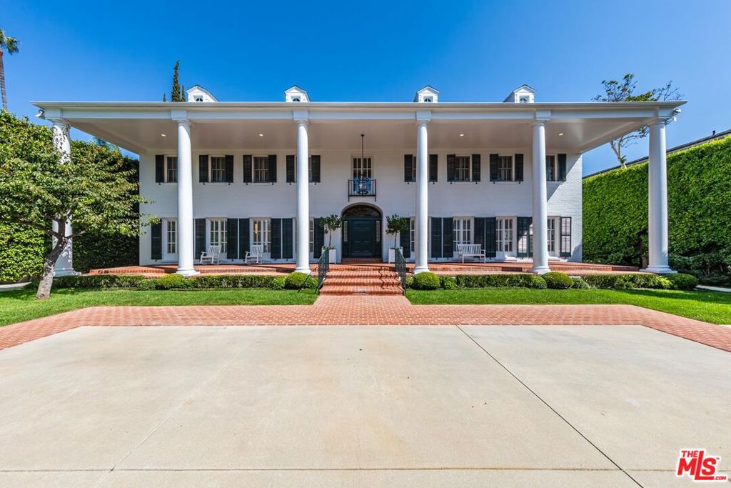 Beverly Hills Trophy Compound on 35,700sqft+ lot. First time available in decades, with renovations by renowned architect Paul Williams. A classic icon on the Flats, rare and exceptional in a most central location. Perfect symmetry greets visitors with a glamorous colonnade and vast gated motor court. Elegant proportions in all public rooms. Signature Oval staircase, light filled living room with fireplace. Adjacent screening room and step-down library/office with French doors to verdant gardens. Formal spacious dining room with fireplace. Veranda overlooks large pool and pool house. Fully lit tennis court with viewing pavilion. Primary suite is a world apart with sitting room, office, marble bath and large walk-in closets. Four additional bedrooms upstairs and 2 staff rooms off kitchen. A vast meadow of grass is the centerpiece of the manicured grounds. 2 bedroom guest house with living room and kitchen is sited above an oversized 3 car garage. Beyond special and unique. Shown to prequalified buyers.