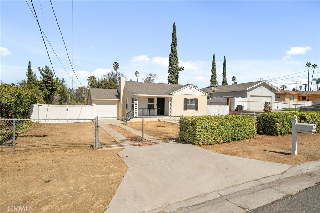 Charming Riverside home with timeless appeal, fully fenced for privacy and comfort. The property offers a spacious yard, a one-car attached garage, and the convenience of RV or boat parking with gated access. Inside, you’ll find warm hardwood flooring, a welcoming living room with a cozy fireplace, and a dining room with French doors that open to the backyard. The galley-style kitchen connects easily to both the dining and family rooms, creating a functional flow. Two spacious bedrooms and the one bathroom features a classic shower-in-tub design, adding to the home’s vintage charm. Outside, a large backyard with a covered patio provides endless possibilities for entertaining, gardening, or simply enjoying the open space.