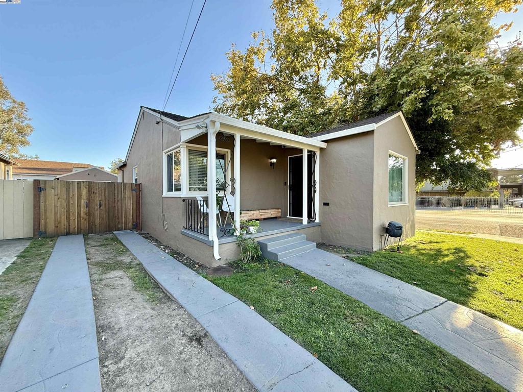 Welcome to this adorable 2-bedroom, 1-bath single-family home offering 1,030 sq. ft. of comfortable living space. Step inside to a bright and inviting living room featuring beautiful hardwood floors and an updated fireplace — perfect for cozy evenings. The adjacent dining room also boasts hardwood floors, creating a warm and cohesive flow throughout the main living areas. The galley-style kitchen has been refreshed with new flooring, granite countertops, and a convenient built-in bench seating area, ideal for casual meals or morning coffee. Both bedrooms are generously sized, and the updated bathroom offers a clean, modern touch. Outside, enjoy a detached garage and a large backyard. Recent updates include a new redwood fence, updated fireplace, crown molding, central heating and air, interior and exterior paint, new water heater, upgraded electrical panel, and new privacy trees with irrigation. This charming home beautifully combines modern updates with classic character — a must-see!