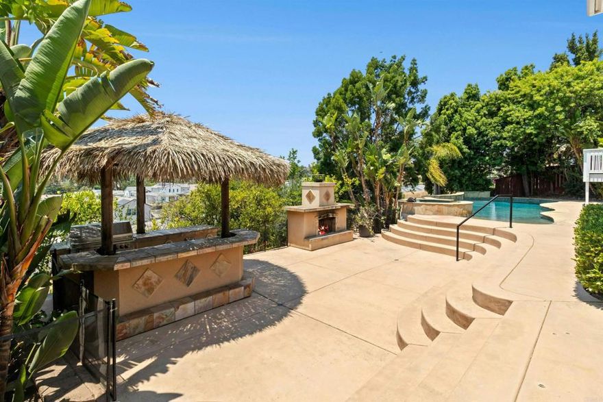 Tucked away in a quiet neighborhood, this beautifully maintained 3-bedroom, 2.5-bath home plus bonus room offers the perfect blend of comfort, function, and outdoor living. The reverse floor plan places the main living areas upstairs to take full advantage of sweeping mountain and tree-lined views. Cherrywood floors add warmth and charm to the upper level, where you’ll find a light-filled family room, dining area, and a spacious kitchen—all flowing seamlessly to a newly built deck, ideal for enjoying colorful sunsets and morning coffee alike. Downstairs, the bedrooms offer privacy and quiet, while the versatile bonus room is perfect for a home office, gym, or teen hang-out. Step into the large backyard which features a sparkling saltwater pool, relaxing jacuzzi, and a built-in BBQ island under a large palapa for shaded entertaining. Located in the highly sought-after Poway Unified School District and close to hiking trails, shops, and dining, this home is your private escape with all the conveniences of modern living.