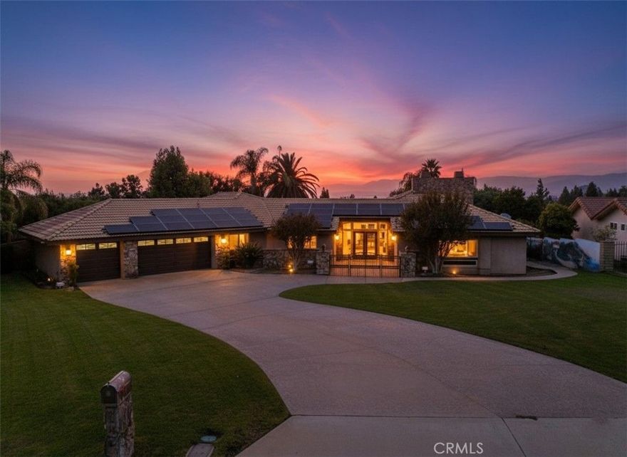 Sited on an elevated lot in Hillcrest, this sprawling single-story residence captures panoramic views over Downtown Riverside and the surrounding mountains, while offering a rare combination of privacy and open space.  A stained and stamped driveway, flanked by mature landscaping, descends to a gated front courtyard. Inside, spacious living areas are accented by arched entryways, two stone fireplaces, and rich finishes.  Large picture windows are thoughtfully placed, allowing the views to be omnipresent throughout the larger balance of the home. The open kitchen serves as the heart of the home, featuring granite countertops, a center island with gas cooktop, custom cabinetry, breakfast bar, and a dining niche. From here, expansive windows overlook the resort-style backyard, sweeping views, and mature landscape.  The floorplan unfolds down a central hallway, flowing seamlessly between formal and informal spaces.  Lovingly cared for, and thoughtfully enhanced, by the same owners for the past 40 years, this property reflects a sincere pride of ownership. The primary suite is a true retreat, highlighted by a uniquely spacious dressing room with built-in custom cabinetry and organizers, vanity station, and a center island of large drawers.  Additional bedrooms and flex spaces provide versatile options for guests, a home office, or multi-generational living.  Outdoors, a sparkling pool and spa take full advantage of the elevated vantage point, surrounded by manicured grounds designed for relaxation and entertaining. The raised spa is centrally located closer to the residence, both enhancing the views and integrating it into the social gathering areas for a seamless entertainment space.  Just off the pool deck, an attached pool house offers a convenient ¾ bath for guests.  A ribbon of lawn cascades down to the lower tier of the yard and connects with mature trees and bushes, completing the lot.  Other notable features include an oversized 3-car garage, paid solar power system, and a generous .71 acre lot that feels tucked away yet is near local amenities, freeway access, University California at Riverside, and Downtown.
