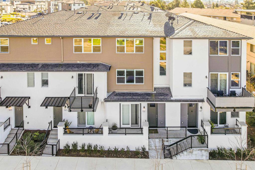 Natural light fills every room in this end-unit townhome within Atlas at Mission Village. This 4-bedroom, 3.5-bath home offers 2,053 SqFt of thoughtfully designed living space. The main level features a private bedroom and full bath, perfect for guests or a home office, along with a finished two-car garage with epoxy-coated floors, pre-wired for EV charging station. The second level is the heart of the home, featuring an open-concept kitchen, dining, and living area, plus a private balcony and half bath. Upgraded appliances, custom tile in all bathrooms, and a primary suite with a custom countertop and upgraded sinks add to the home’s modern appeal. The third level includes the spacious primary suite with walk-in closet, two additional bedrooms, and another full bath. With only one shared wall and triple-pane windows throughout, this home offers both privacy and energy efficiency. It is fully electric with owned solar panels and central A/C, ensuring sustainability without compromising comfort. Perfectly located in the heart of the Bay Area, it provides easy commuting to Silicon Valley and San Francisco via I-880, Hwy 92, and BART. Shopping, dining, parks, and Mission Hills Golf Course are just minutes away.