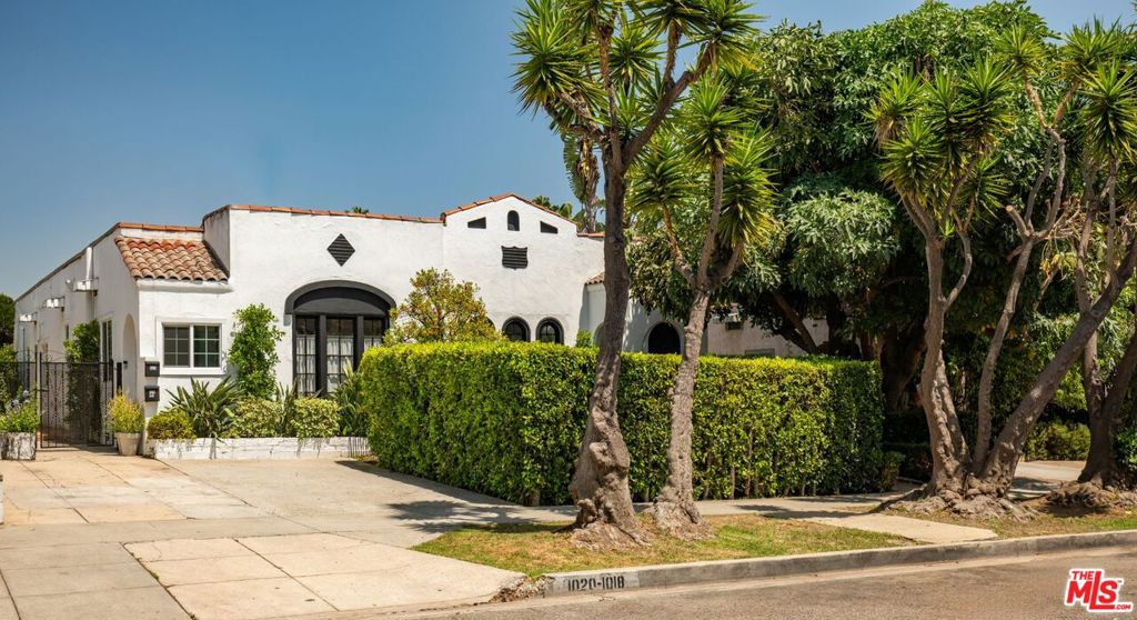 Exceptional Spanish-Style Triplex in Prime West Hollywood. This meticulously maintained Spanish-style triplex exemplifies timeless architectural elegance and pride of ownership in one of West Hollywood's most desirable neighborhoods. Privately situated behind secure gates, the property is enveloped by professionally designed, lush landscaping that creates an immediate sense of tranquility and exclusivity. A manicured front lawn welcomes residents and guests to a palapa-covered outdoor dining pavilion -ideal for sophisticated al fresco entertaining while an elegant fountain in the rear courtyard provides a serene retreat from the vibrant energy of the city. The property features two generously proportioned units at the front, each offering two bedrooms and two bathrooms. Both residences include expansive living and dining areas, along with a spacious primary bedroom featuring a dedicated desk or seating area with direct access to the landscaped rear garden. The secondary bedroom in each unit provides versatile space suitable for family, guests, a home office, or creative studio. Interiors have been thoughtfully updated with designer-quality finishes while preserving the property's original Spanish architectural character. Notable features include custom built-ins, upgraded kitchens finished with premium materials, and enhanced storage solutions throughout. The rear residence is a charming two-bedroom, one-bathroom home complete with private in-unit laundry. This standalone dwelling offers a quiet, independent living experience ideal for long-term tenants, guests, or supplemental income generation. Additional Amenities: The front units share a dedicated common laundry area and benefit from off-street parking- highly sought-after feature in this prime West Hollywood location. This thoughtful configuration provides new ownership with flexibility for personal use while maintaining strong rental income potential. Investment Opportunity: With its authentic Spanish character, inviting indoor-outdoor living spaces, and high-demand location, this triplex represents a rare opportunity to acquire a trophy asset with established income streams and significant upside potential.