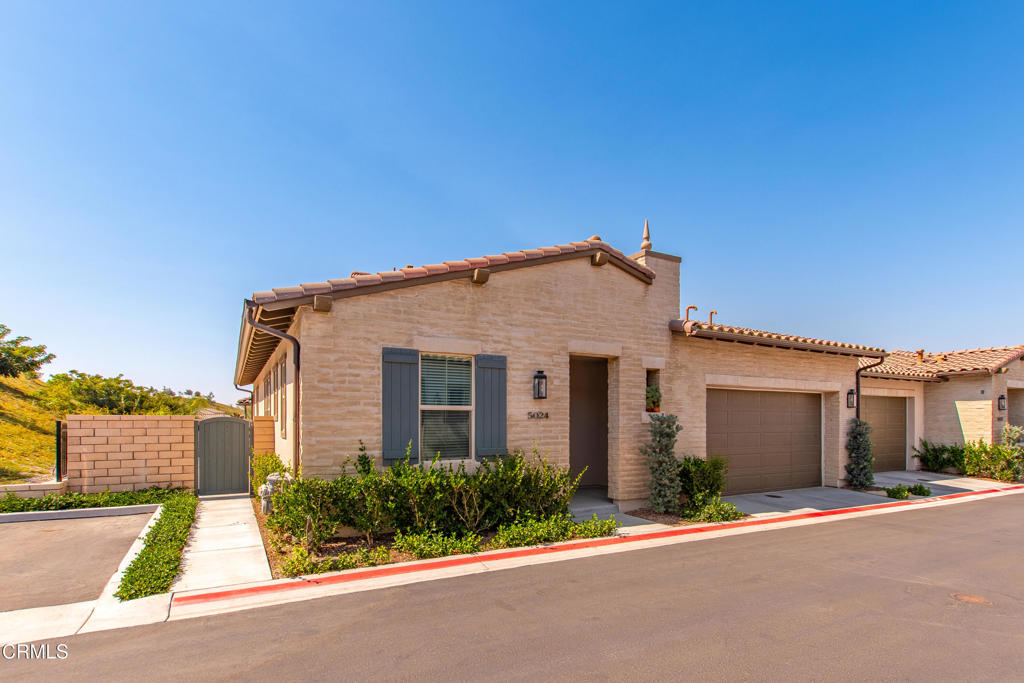 Welcome to resort-style living in The Grove, a private gated 55+ retirement community in Camarillo! This newer-built Pomelo model Residence 2 offers 1,519 square feet of luxurious, thoughtfully designed space, with 2 bedrooms, 2.5 bathrooms, and a versatile den/office. With a secluded location and plenty of guest parking nearby, this home truly feels like a private retreat.The open-concept floor plan exudes modern comfort, featuring neutral vinyl plank flooring, dual pane windows, and white wood blinds throughout. The stylish kitchen boasts soft-close white shaker cabinets, granite counters, stainless steel appliances, and recessed lighting. The living room includes a mounted TV and opens to a covered patio with a ceiling fan, ideal for relaxing or entertaining.Outdoor spaces include an extra-wide side yard and a private wrap-around patio with serene hillside views. Inside, an efficient whole-house fan helps keep cool air flowing in the summer, saving on electricity bills. The guest bedroom features an en-suite bathroom with a shower/tub combination, while a convenient half bath is located in the hallway. The spacious primary bedroom is a true retreat with a mounted TV, walk-in closet, and spa-inspired bathroom with double sinks and a large walk-in shower.Additional highlights include a 2-car garage with a Level 2 50A EV charger, an office/den, an in-unit washer/dryer, and WiFi included in the lease. Residents also enjoy The Grove's extensive amenities, including a pool, spa, pickleball courts, mini golf, two dog parks, fitness center, and private walking trails around the community. With numerous clubs to join, you'll find a vibrant, connected lifestyle awaiting. Don't miss this rare leasing opportunity--many missed out on purchasing in this exclusive community, so make it yours today!