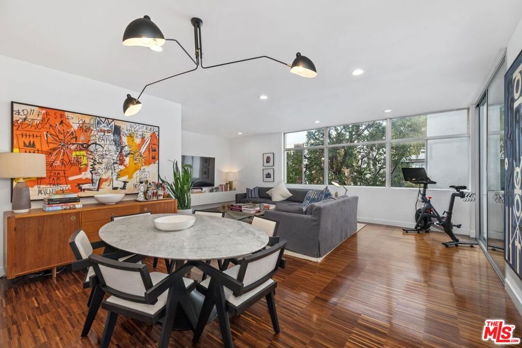 Experience mid-century living in a spacious condo at the base of the Hollywood Hills. This recently remodeled unit boasts an open floor plan, high ceilings, and oversized windows that welcome in abundant California natural light year-round. Beyond its highly desirable location, this home truly has it all: a large living and dining area, a primary bedroom with a walk-in closet featuring custom California Closets built-ins, and a private patio accessible from both the bedroom and living room. The updated chef's kitchen is equipped with Bosch appliances, a wine fridge, induction stove, and granite countertops. Smart home features include Nest devices for the new HVAC system and Crestron-enabled lighting controls. The building offers a community pool, laundry room, and additional storage. The unit comes with one oversized dedicated parking space, plus ample street parking available on Selma and Hayworth. Located in a quiet neighborhood within blocks from everything Sunset Boulevard and West Hollywood have to offer.