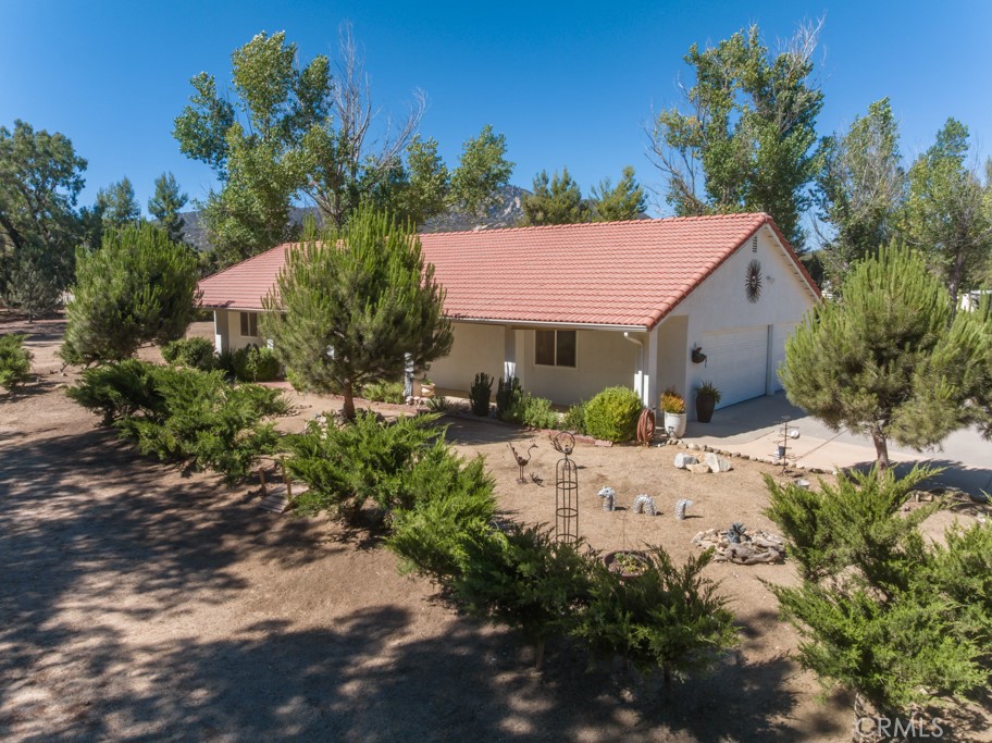 This is THE ONE!!!! Located in the beautiful community of Lake Riverside Estates only 25 min outside of Temecula is the gorgeous Mediterranean Style custom ranch home. This turnkey property is immaculately maintained with upgrades on a fully flat, fenced and usable 2.7 acres graced with mature trees throughout the entire property. Truly your own park retreat setting!!!! Horse keeping area with covered stalls and turnout, tack/feed room and miles of direct access trails. No horses? That's okay this is a great outdoor storage area, gym area or whatever your delight. The home is a fabulous classic ranch style but has been upgraded with newer large picture windows and extra wide and tall glass doors/sliders for optimum light and views! HVAC just replaced in Nov 2024, all new breakers (except one) with refurbished electrical panel. Private well with great water quality, circular concrete drive, decorative wrought iron fencing, outdoor patio/dining area, separate black chain link fenced-in pet area (or play area), PRIVACY with surrounding large junipers keeping your private park, private!!!! The flow of the floorplan of the home is wonderfully open and bright allowing for views of all the outdoor trees and mountains. The spacious living area opens to an additional family/dining area with fireplace which opens to a wonderful kitchen with pantry and lots of storage cabinetry. Several lighting fixtures, door handles and fixtures have been updated. Bonus, an insulated MUSIC STUDEO!!!! The garage has a built in sound insulated music studio which could also be used as a home office or other bonus room (this could also be removed to restore the interior space of the garage if wanted). In the primary suite you will find an oversized walk in closet and sliding door access to private rear yard/patio with mountain views! The exterior of the home is in wonderful condition with stucco and concrete tile roof. Lots of room for RV/Boat/Trailer parking. This home is truly in wonderful condition, the property is clean and maintained, the setting is an absolute retreat and the location is splendid just a block up from paved entrance road to the community. Lake Riverside offers many amenities including a private lake for picnics, bird watching, catch and release fishing (non gas boats are welcomed), an equestrian arena, round pen and stalls, a 3600 ft lighted and paved airstrip for residents and guests, sports courts, community pool and more. Cal Fire is Close! A true Gem.