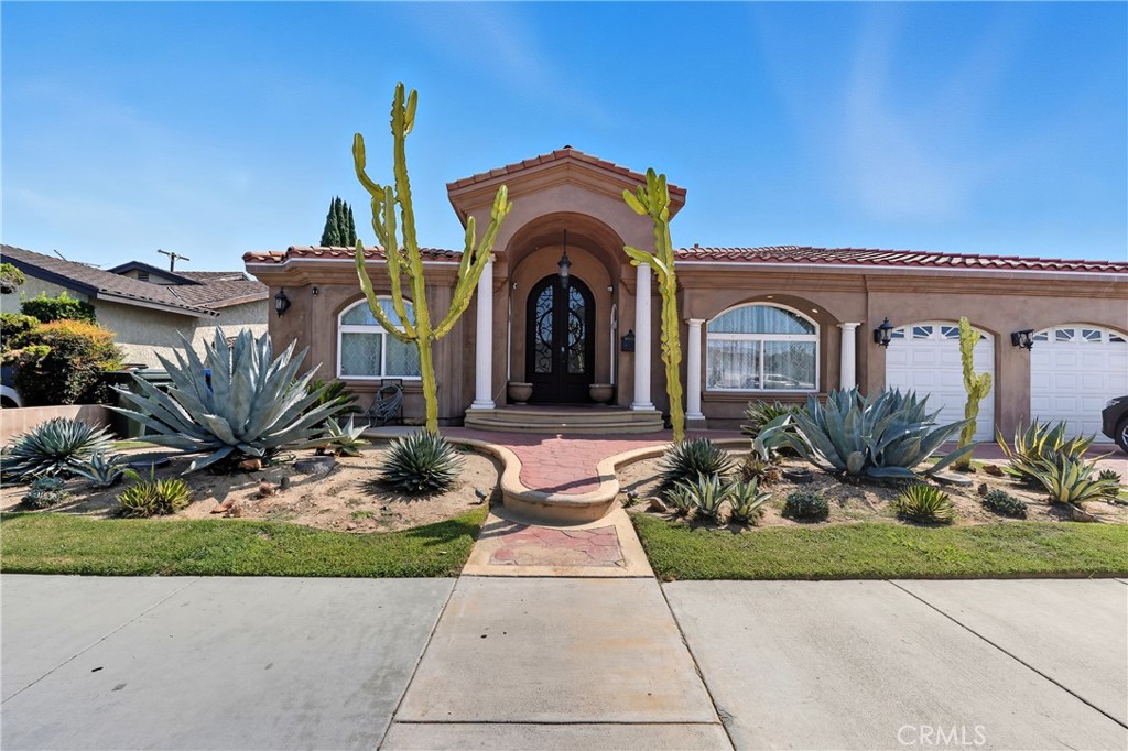 Welcome to 10702 Old River School Rd, an exceptional modern Spanish-style residence offering sophistication and comfort in the heart of Downey. Perfectly located across from Rio Hondo Golf Course, this home showcases timeless curb appeal with its arched entryways, tiled roof, and desert-inspired landscaping. Inside, the home opens into an expansive open-concept living and dining area with hardwood floors, recessed lighting, and dramatic tray ceilings that create a light-filled, airy atmosphere. The layout flows seamlessly into the gourmet kitchen, complete with custom cabinetry, sleek counters, and a large island ideal for both casual dining and entertaining. The grand master suite is a true retreat, featuring a spacious walk-in closet with built-in organizers and a spa-inspired bathroom. Relax in the freestanding soaking tub framed by picture windows or refresh in the oversized walk-in rainfall shower accented with designer tile. Dual vanities and elegant finishes complete the suite’s luxury feel. Two additional bedrooms are thoughtfully connected by a stylish Jack & Jill bathroom with double sinks and modern lighting. On the opposite side of the home, a private 4th bedroom with its own full bath offers the perfect setup for guests or multigenerational living. The home also includes a guest half bath for added convenience, a dedicated laundry room with built-in storage, and direct garage access for everyday functionality. A spacious family/media room with a custom stone fireplace wall adds to the home’s versatility and comfort. Outdoors, the generous backyard provides endless possibilities — perfect for entertaining, gardening, or simply enjoying the California sunshine. Nestled in a highly sought-after pocket of Downey, this home is just minutes from acclaimed schools like Rio Hondo Elementary, Griffiths Middle, and Warren High, local favorites including Porto’s Bakery, Tropicana Bakery & Cuban Café, and downtown Downey’s vibrant restaurant scene. For commuters, the property offers quick freeway access to the 5, 605, and 710, putting Los Angeles and Orange County within easy reach. Come by and see it for yourself!