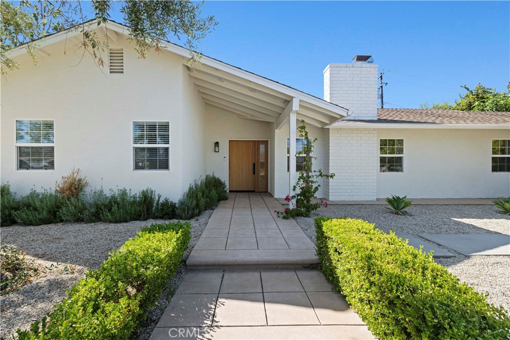 This stunning single-story luxury residence offers the rare opportunity to own a completely re-imagined home in the heart of Thousand Oaks. With 4 bedrooms, 3 full bathrooms, and just under 2,100 sq. ft. of thoughtfully designed living space, every inch has been transformed with meticulous attention to detail and high-end finishes, making it feel like new construction.
Step through the custom white oak front door and into an open, airy floor plan bathed in natural light. Brand-new luxury flooring flows seamlessly throughout, complementing the organic modern design. The showpiece kitchen is a chef’s dream, boasting Taj Mahal quartzite countertops with a waterfall island, custom cabinetry with Restoration Hardware accents, and top-of-the-line Viking appliances.
Each bathroom has been tastefully remodeled with spa-like finishes, while the limestone wash fireplace and flush recessed vents add subtle sophistication to the living areas. Additional upgrades include a brand-new AC and heating system, recessed lighting with a nightlight feature, Nest smart home integration, and freshly painted interiors and exteriors.
The lifestyle continues outdoors with a newly built cedar wood pergola perfect for entertaining, a finished garage with a full-view luxury glass door, built-in laundry station and cabinets, and a pool-sized backyard framed by mature fruit trees.
This isn’t just a renovation, it’s a reinvention. A home where every detail feels purposeful, elevated, and timeless.